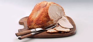 How to cook a turkey crown 6 - How To Make Roast turkey on a wooden board with three slices carved