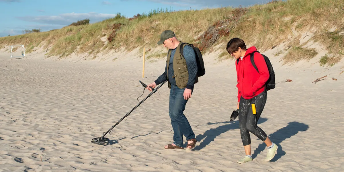 584b75a397c2-metal-detecting-on-beach.webp