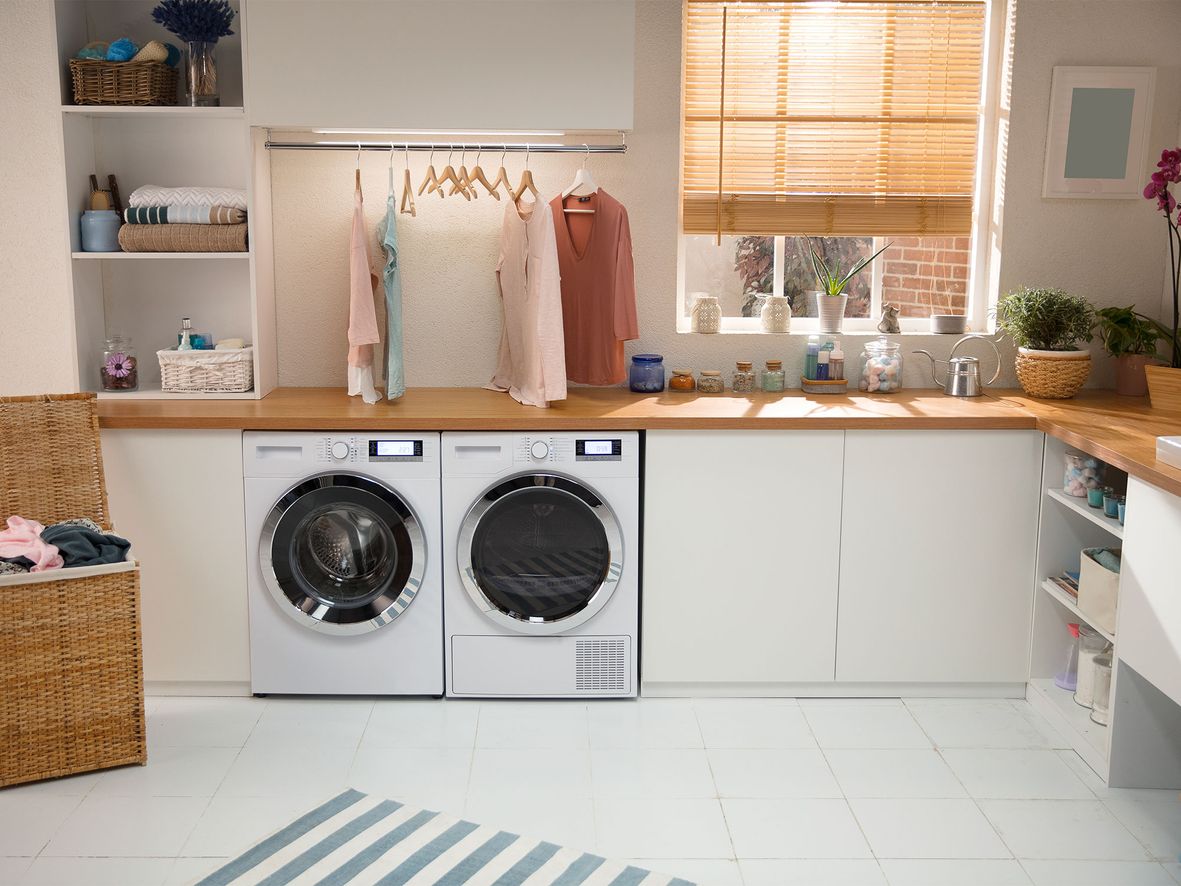 A rail above your appliances gives you somewhere to hang slightly damp clothes to finish drying. Glass jars are a chic alternative to displaying packets of washing powder and bottles of laundry softener.