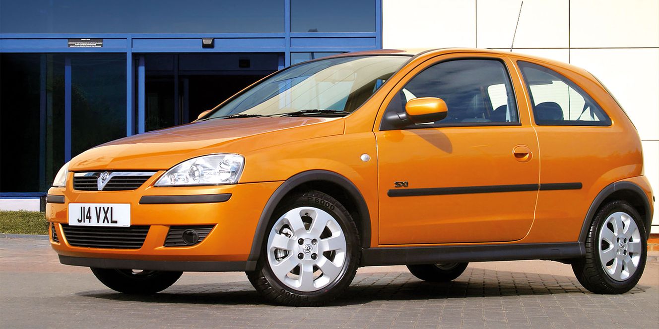 Orange Vauxhall Corsa on a brick road