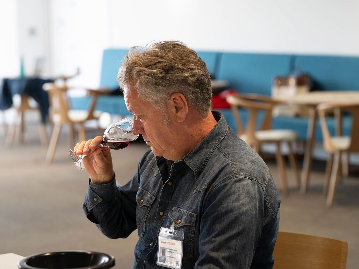 Wine expert Peter McCombie judging a red wine during our taste test