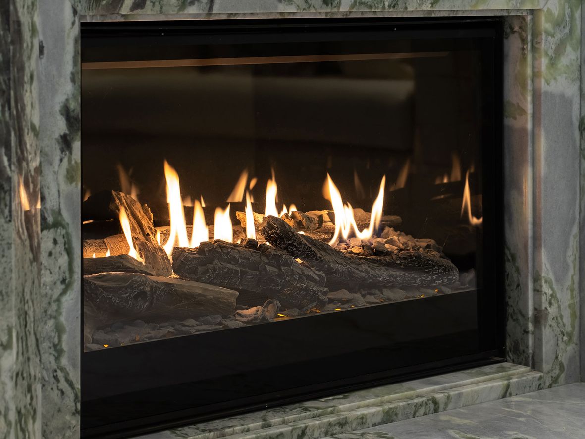 A modern gas fire with imitation log bed