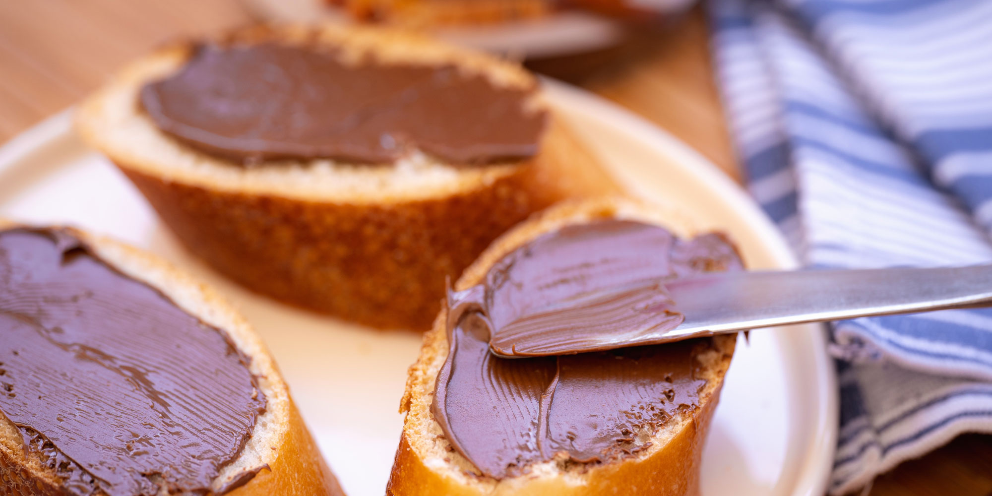 Chocolate hazelnut spread on slices of baguette
