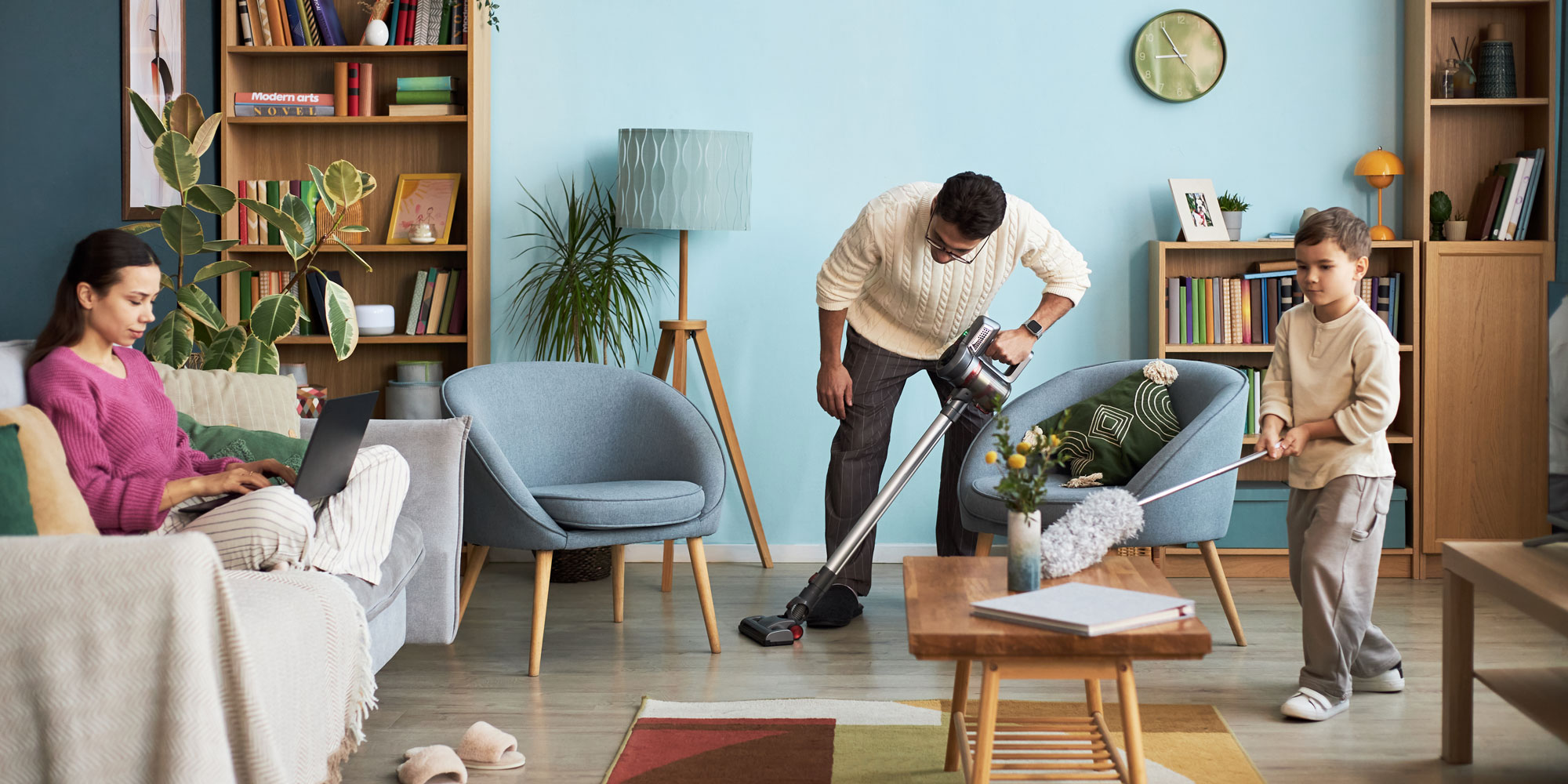 A father and child cleaning up a living room