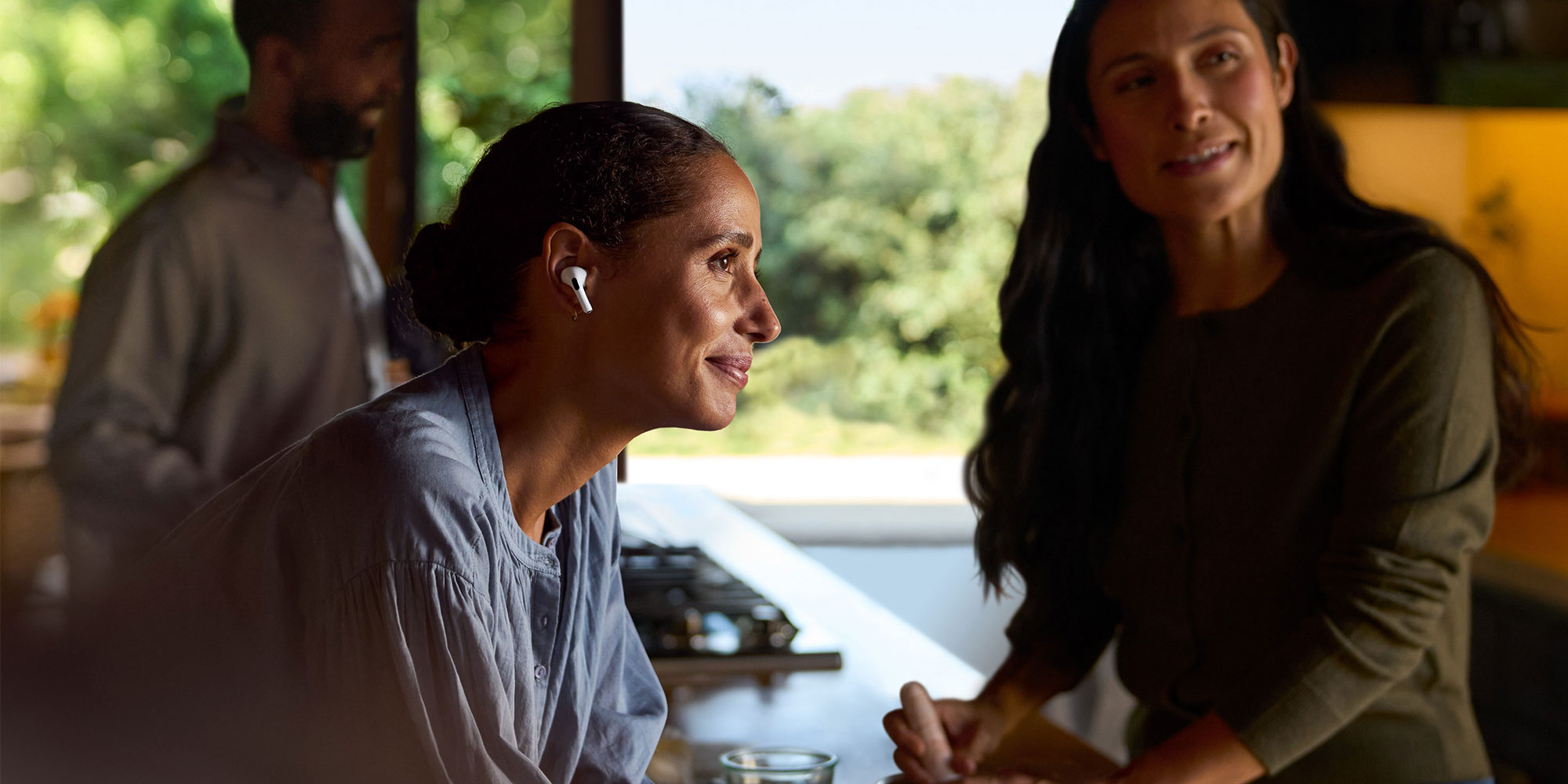 Woman wearing Apple Airpods in a meeting to help with hearing used as an hearing aid 