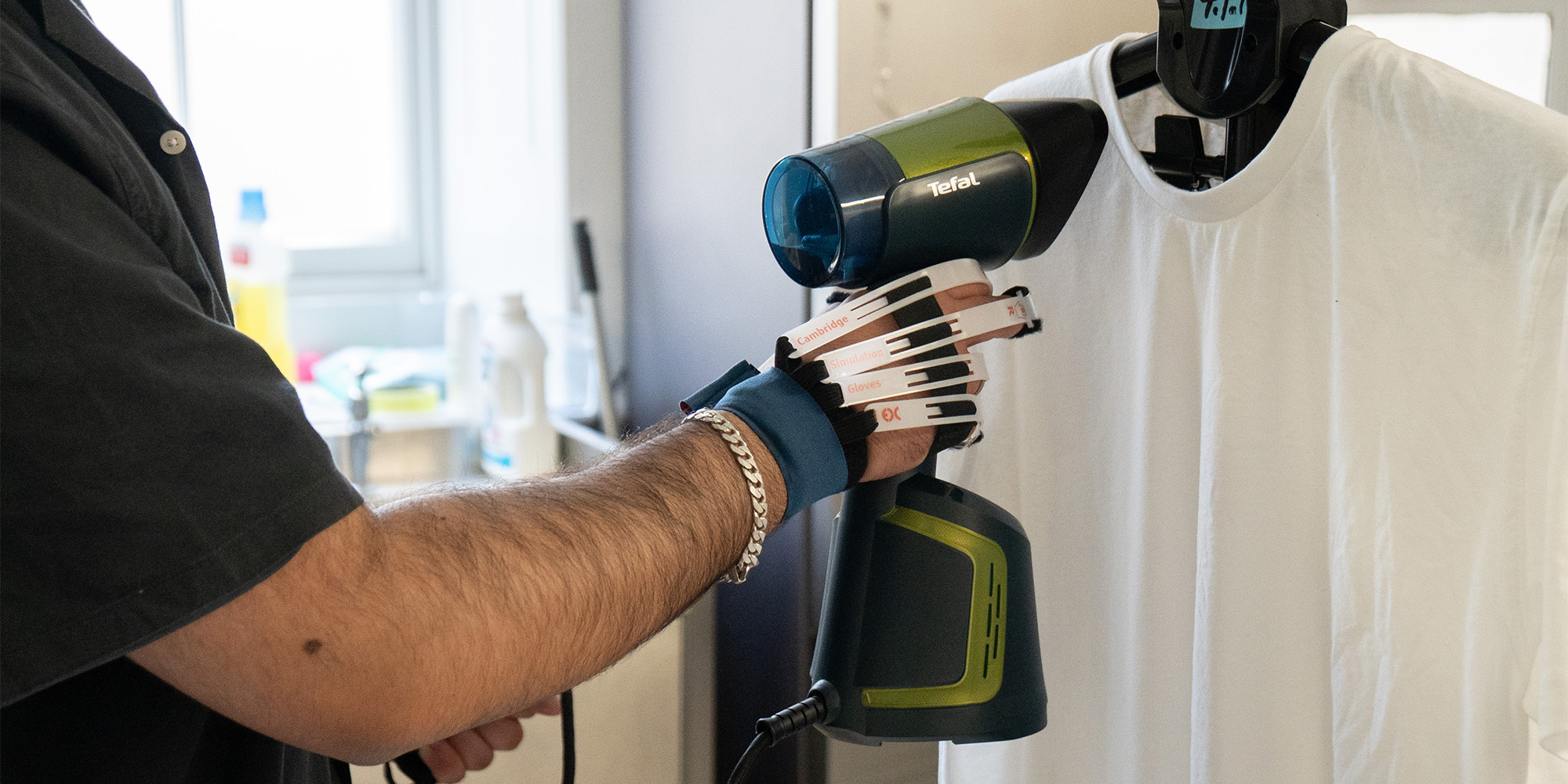 Our tester using the Cambridge gloves to mimic limited hand dexterity.