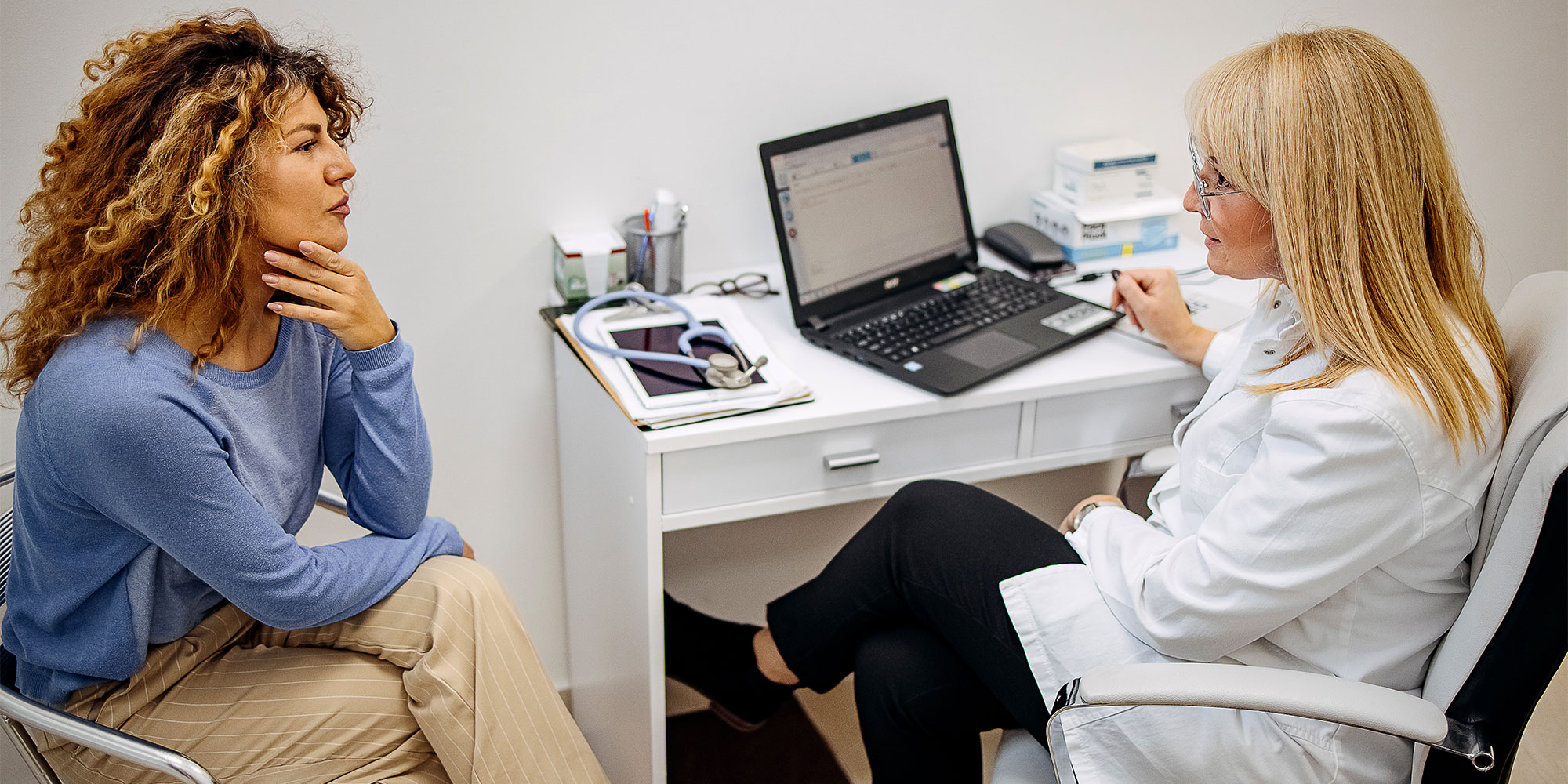 A woman talking to a doctor or GP