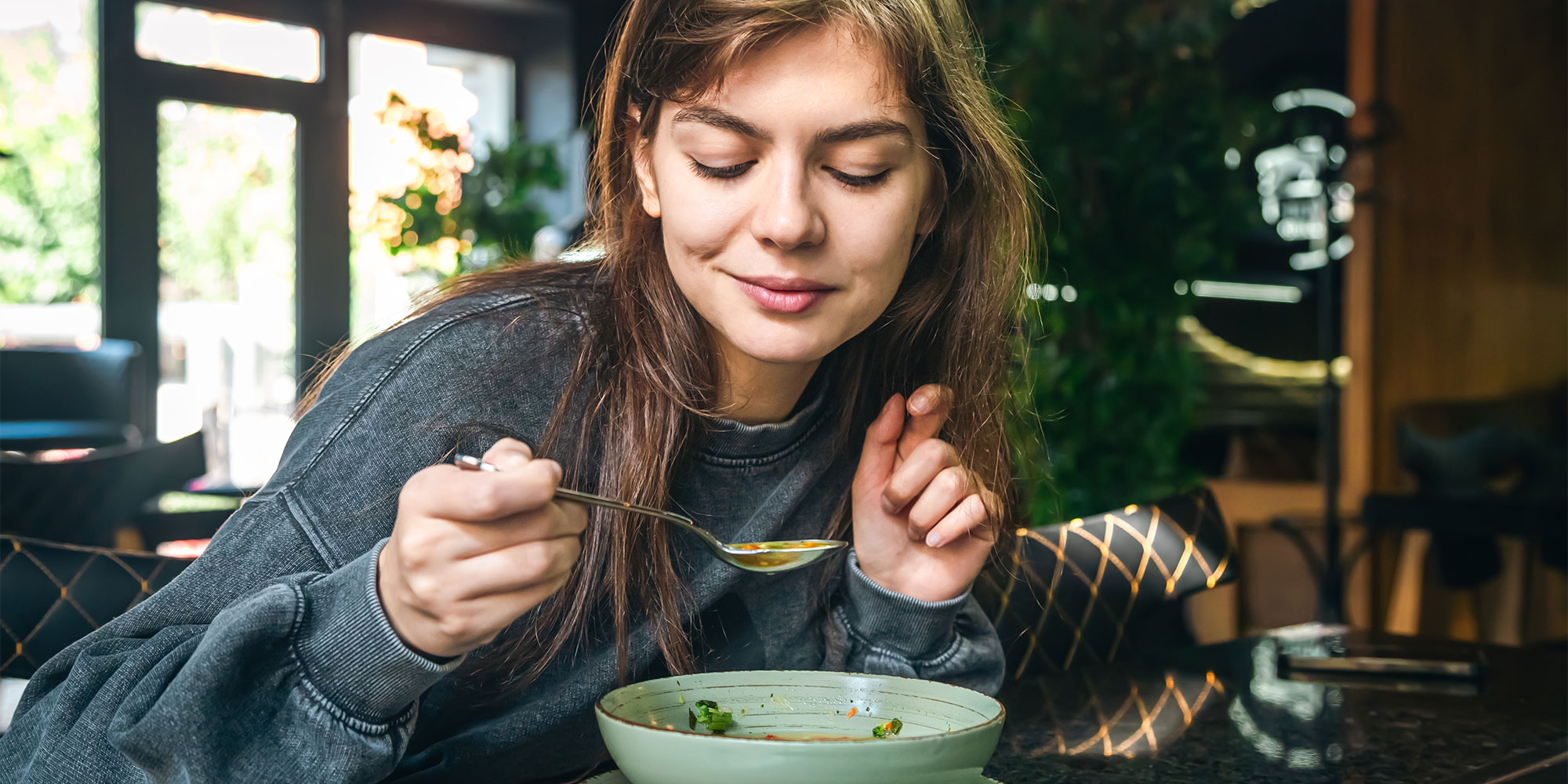 Woman eating bone broth