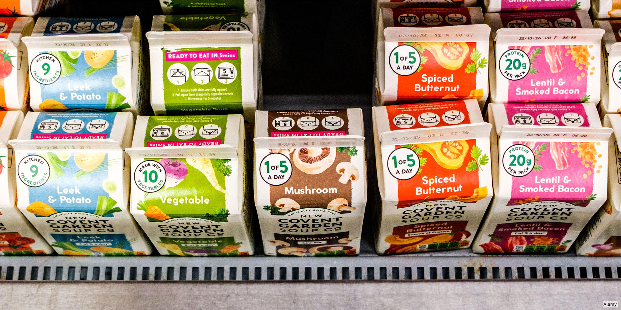 Cartons of fresh soup in a supermarket refrigerated display.