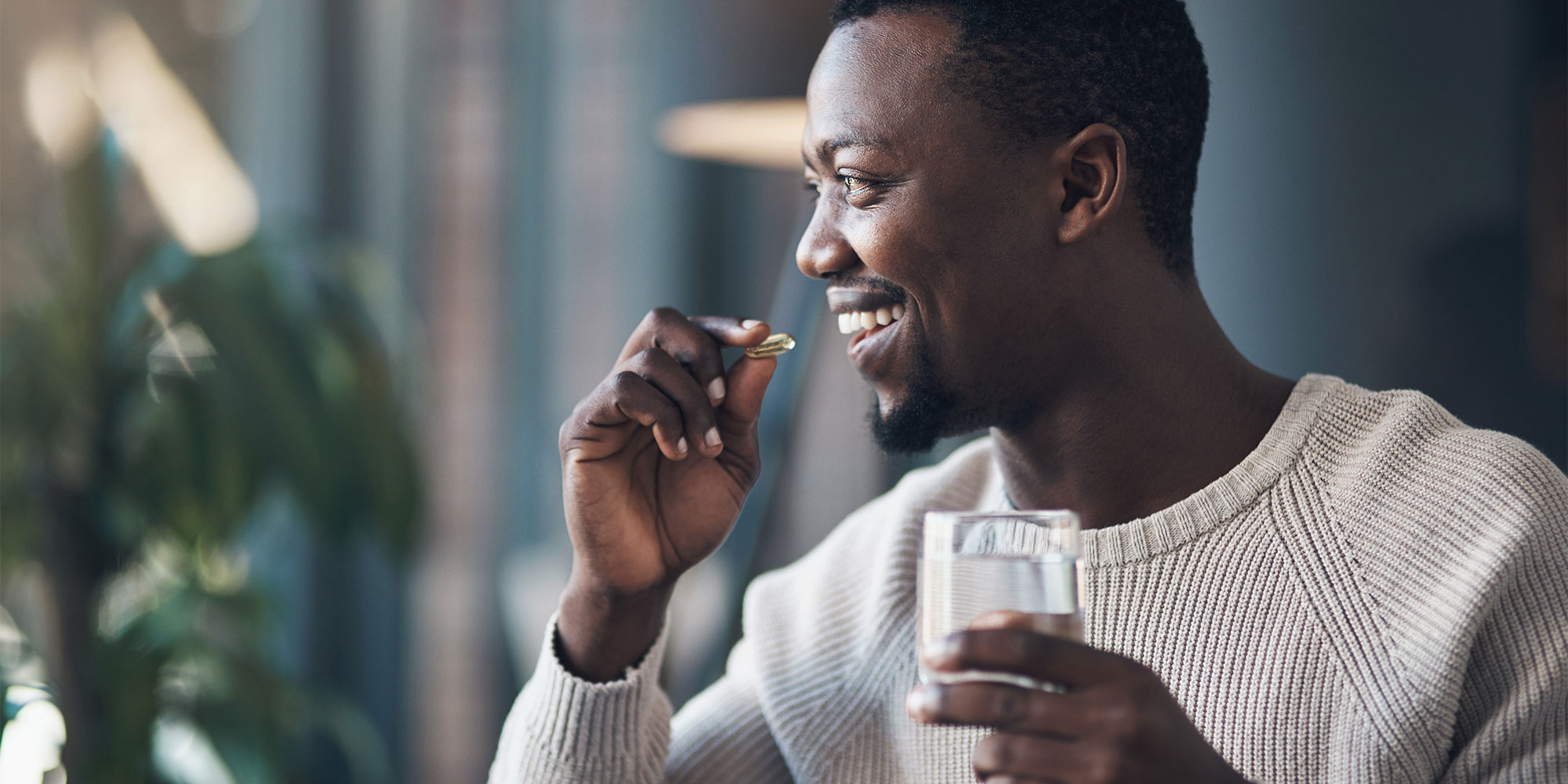 Man with darker skin tone taking supplement