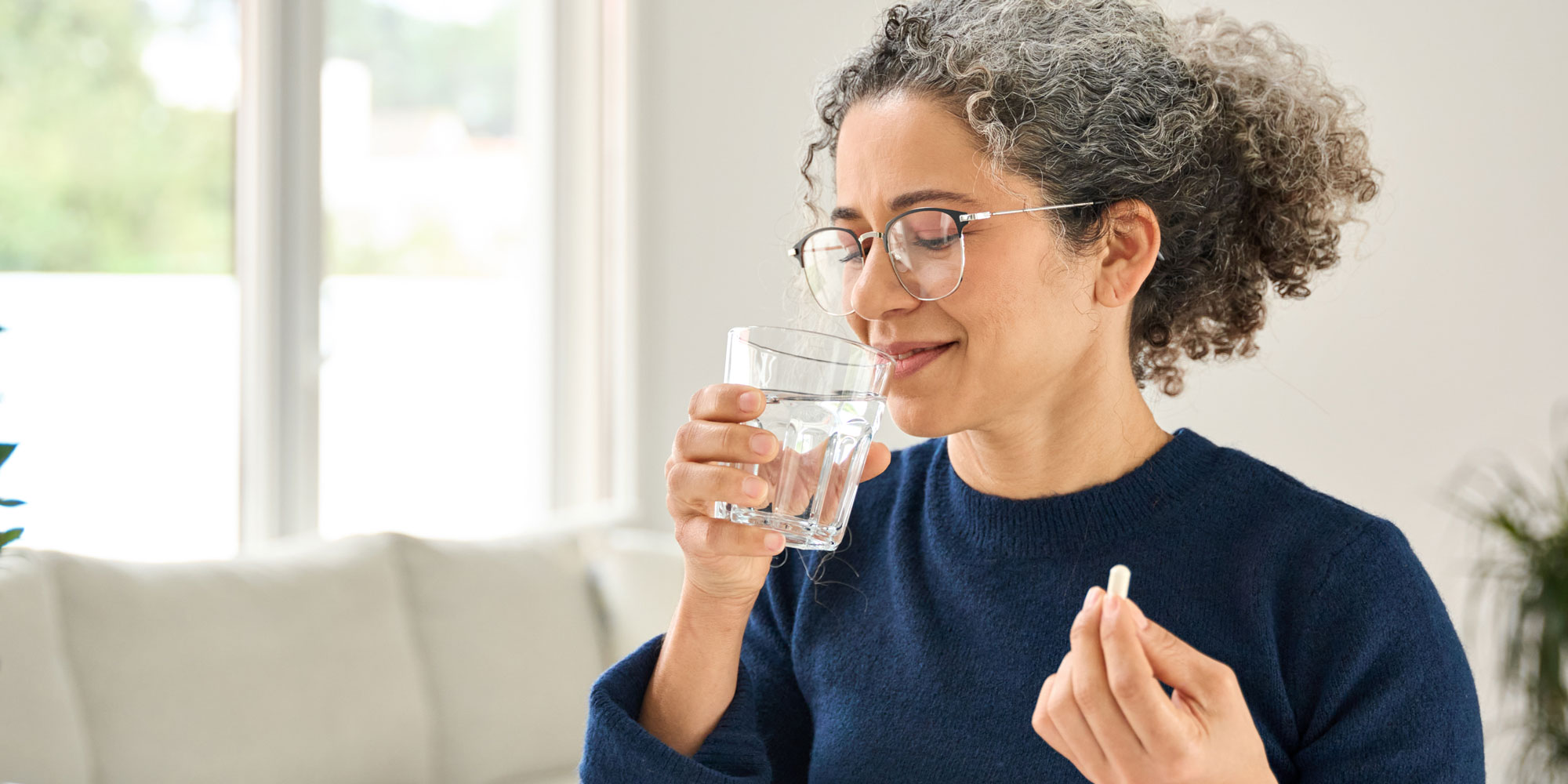 A person taking tablet. 