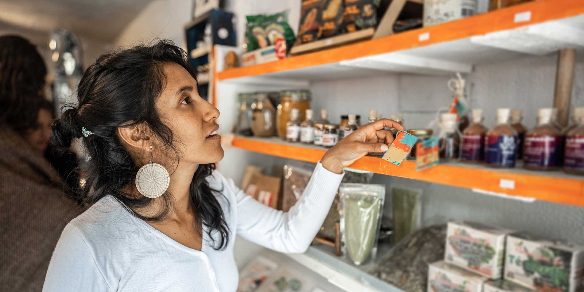 A woman looking at ashwagandha supplements in a store