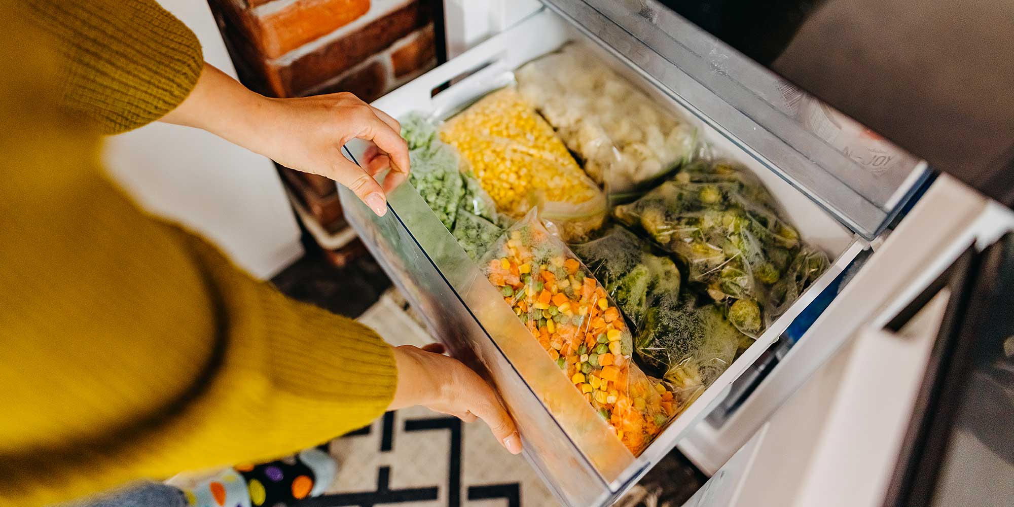 person opening their freezer drawer