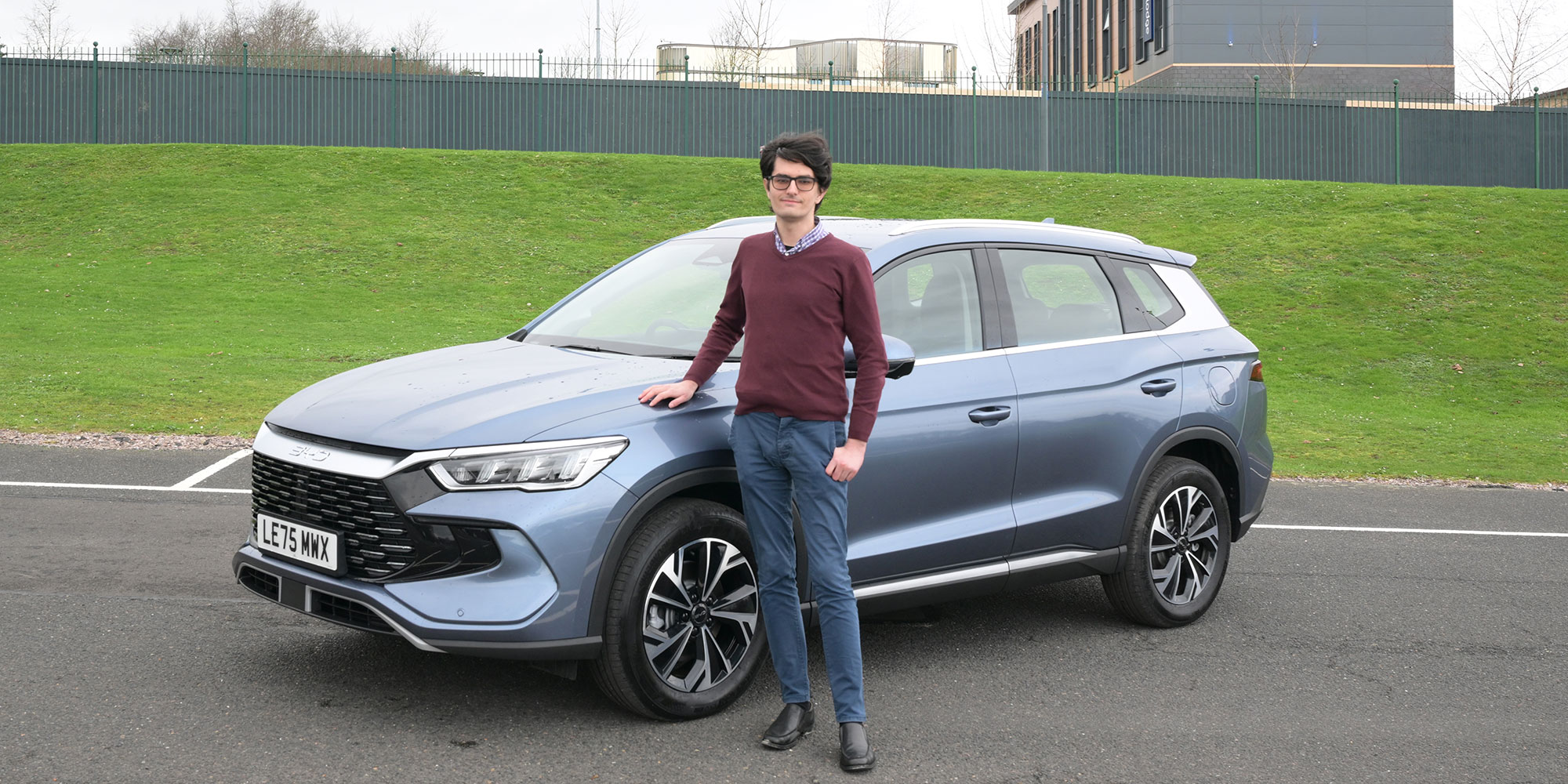 Dino Buratti stands next to a BYD Sealion 5 DM-i SUV