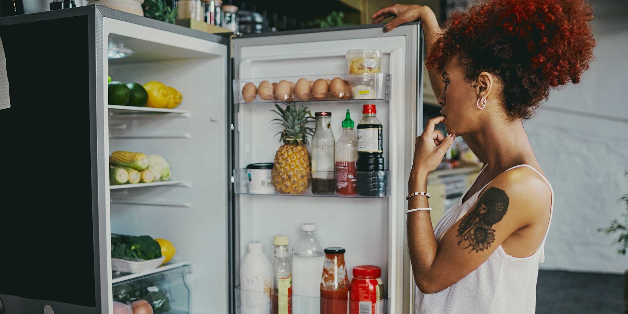 Woman opening fridge