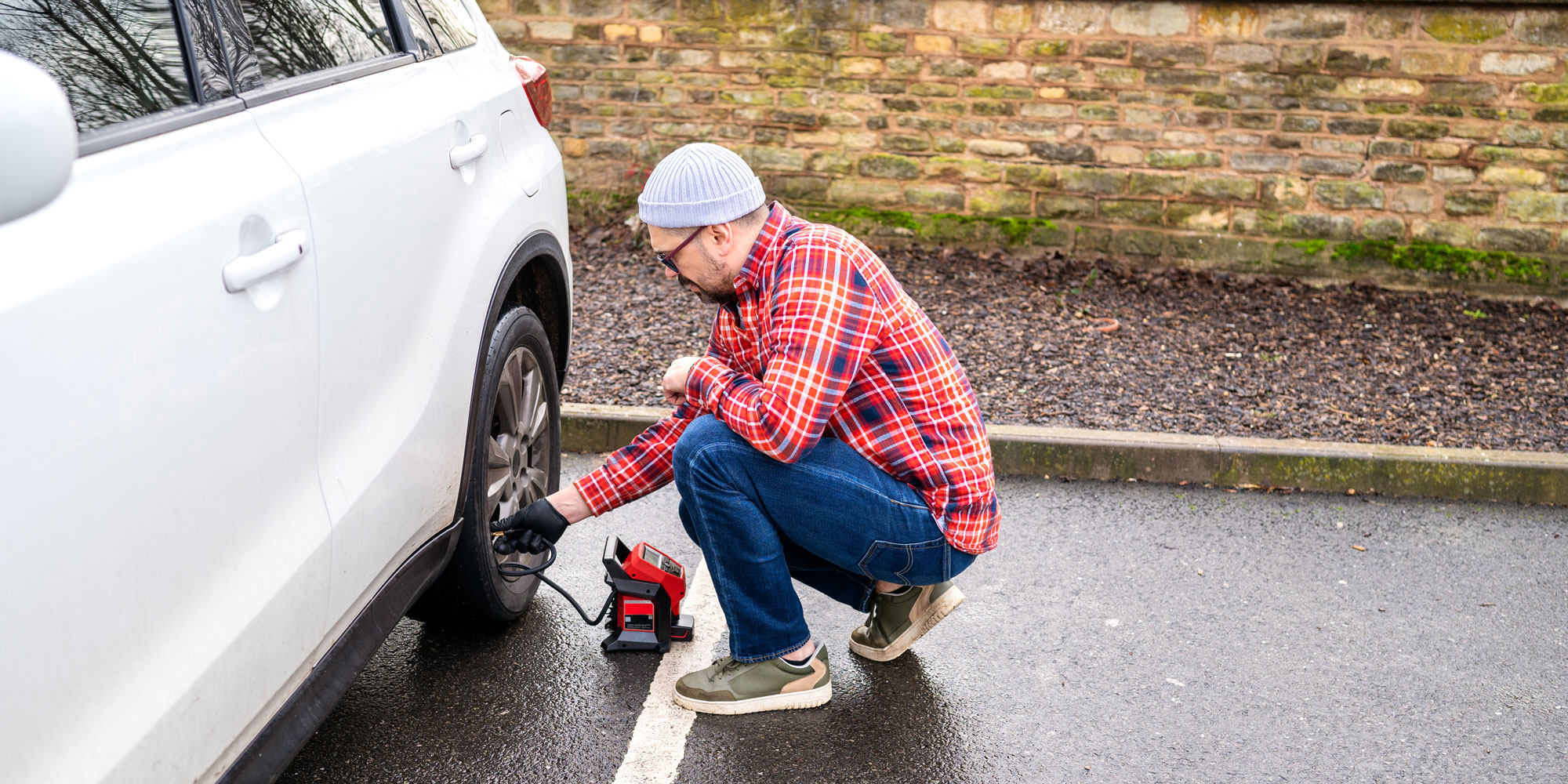 A man using a tyre inflator