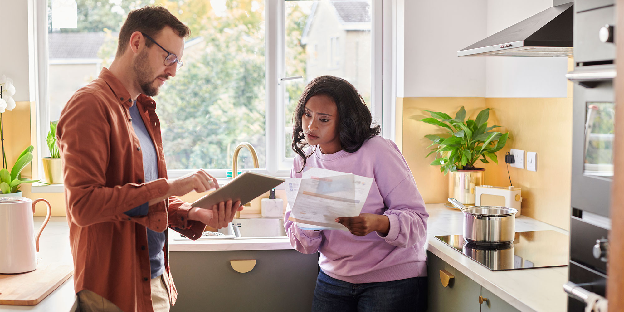 Man and woman comparing energy statement with online account