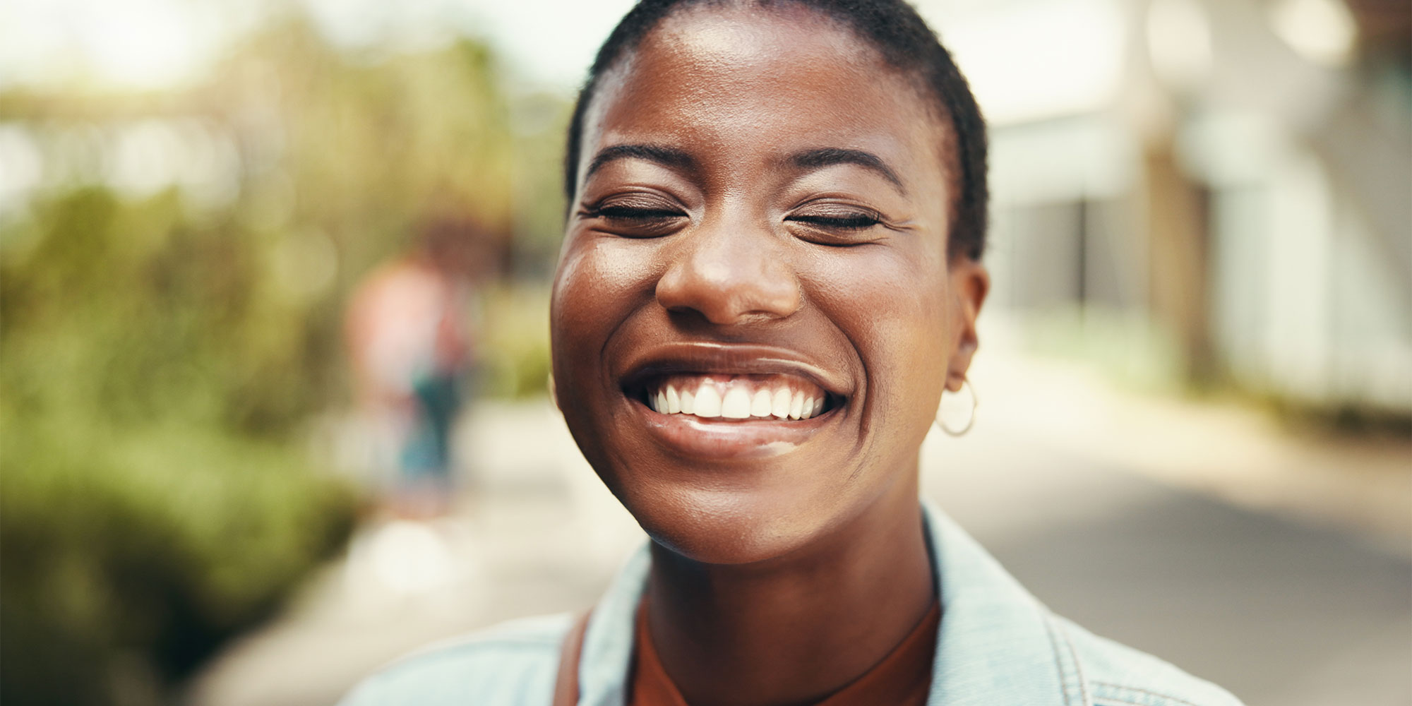 A woman smiling in the street