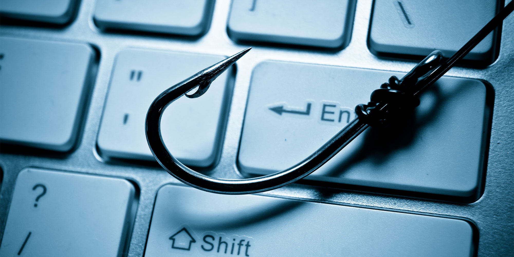 A keyboard with a fishing hook on it