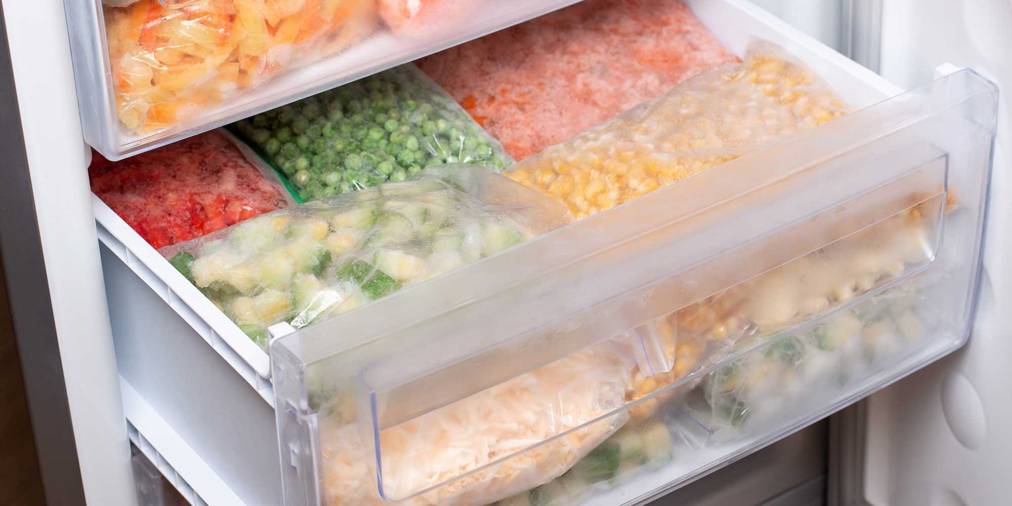 freezer drawer filled with frozen vegetables