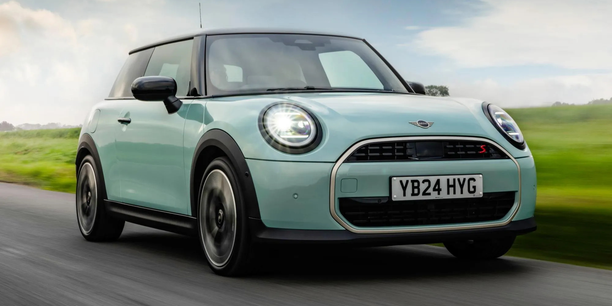 Light green Mini Cooper on a country road
