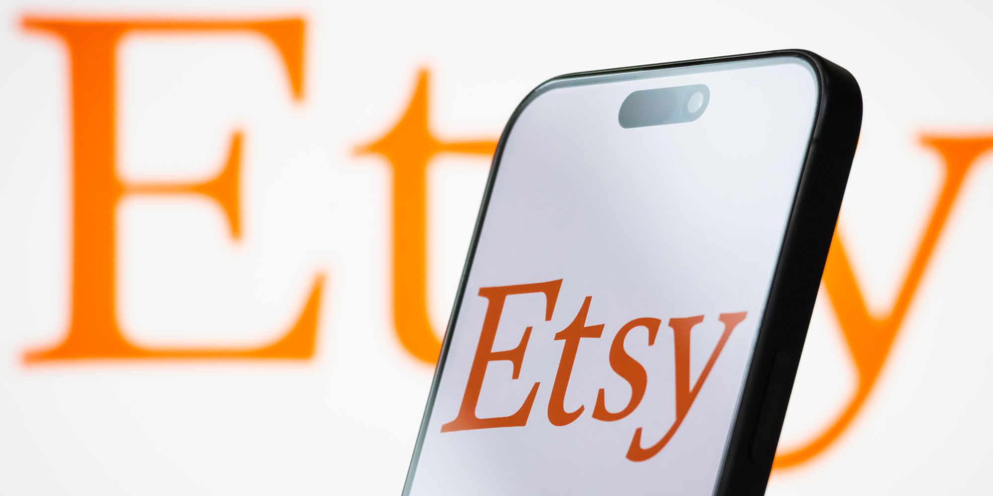 A phone showing the Etsy logo