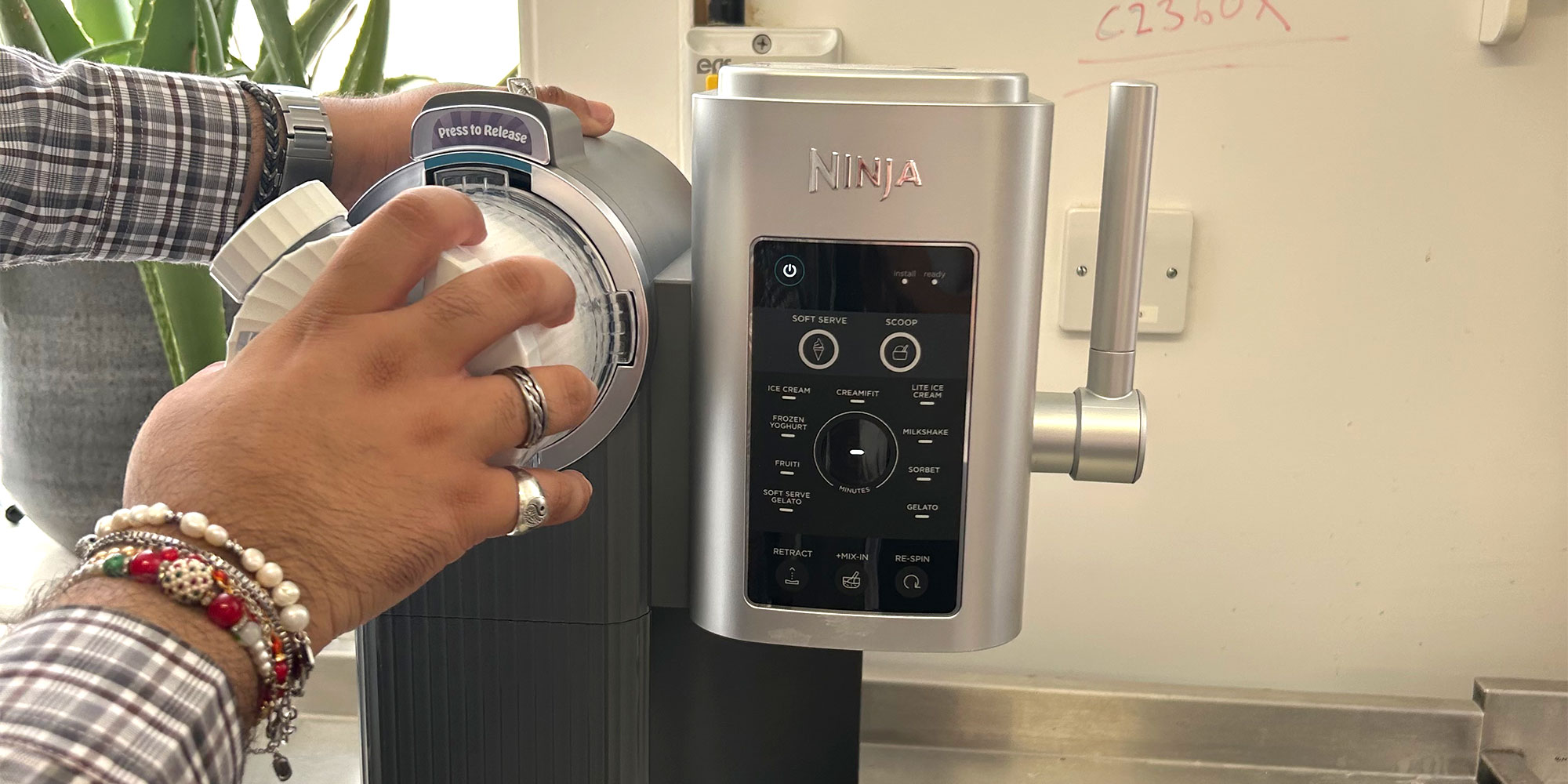Twisting the tub into the soft serve slot of the Ninja Swirl