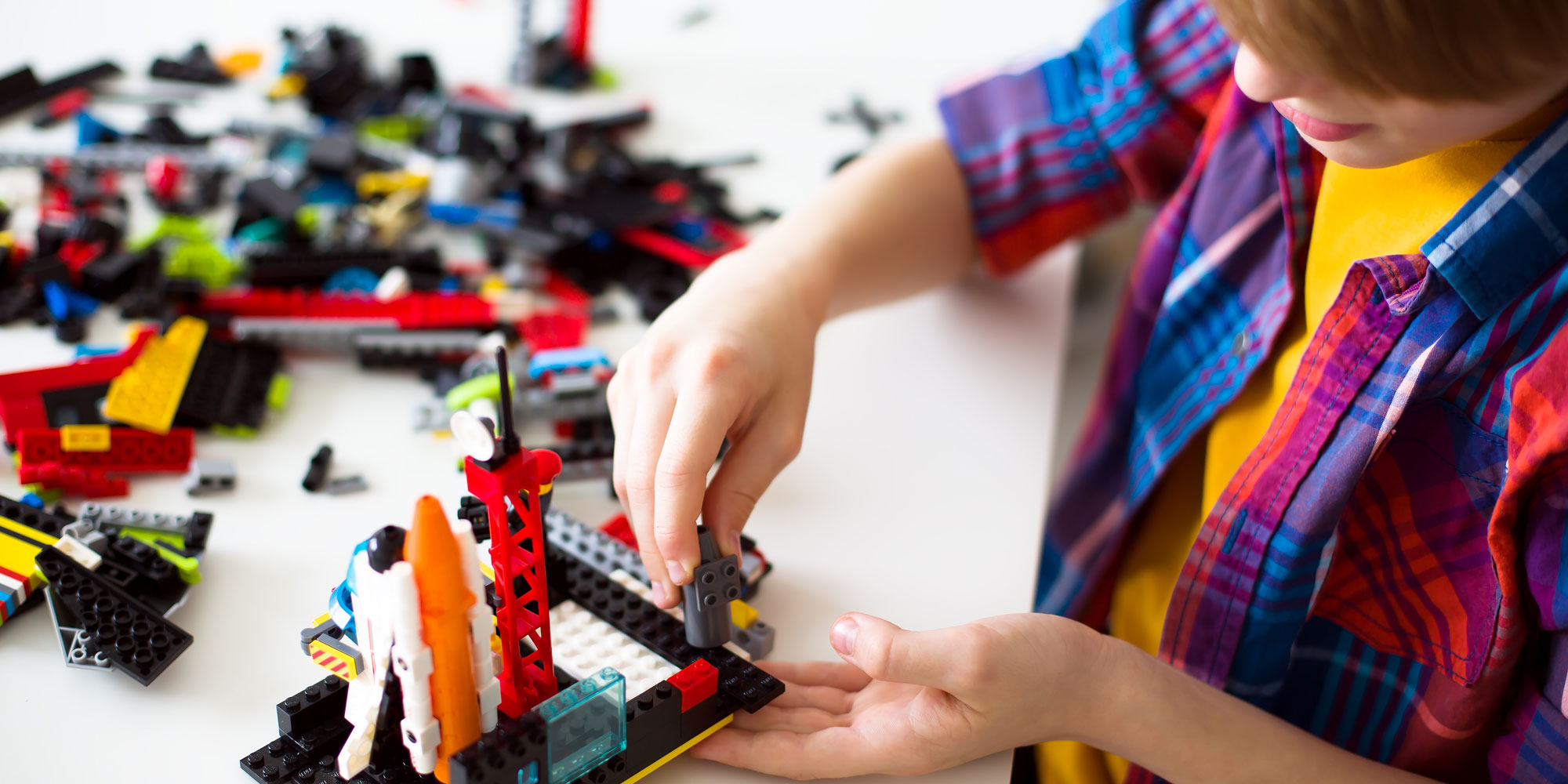 Child playing with Lego