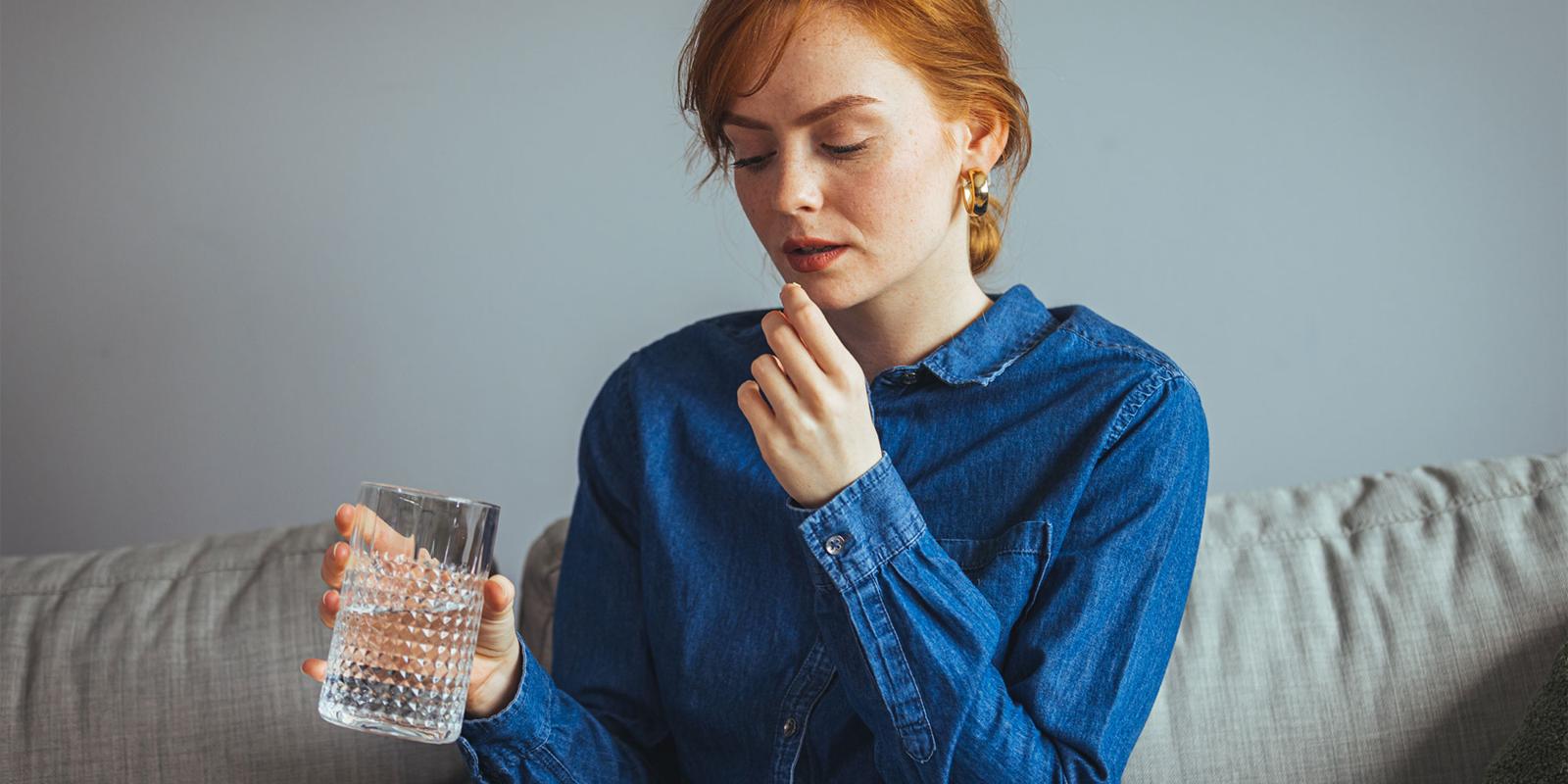 A woman taking a supplement