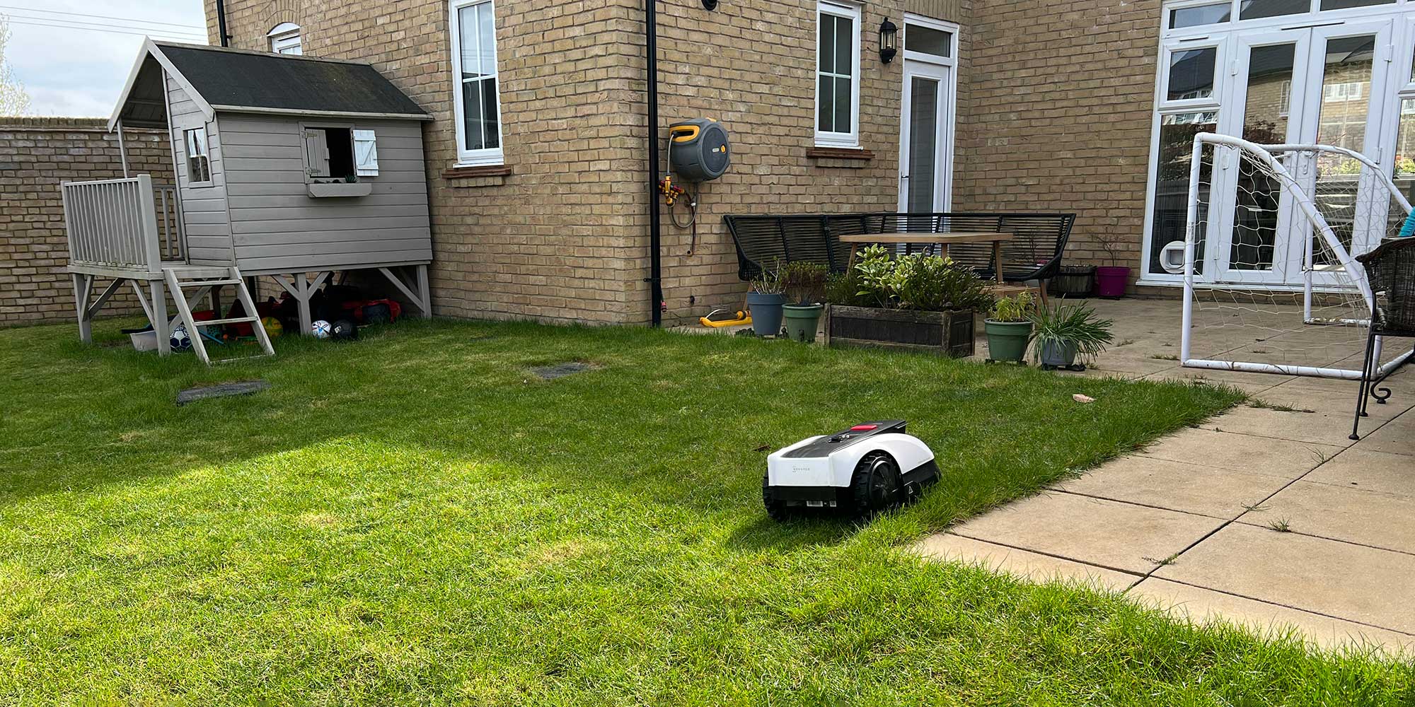 A robot lawnmower in a garden
