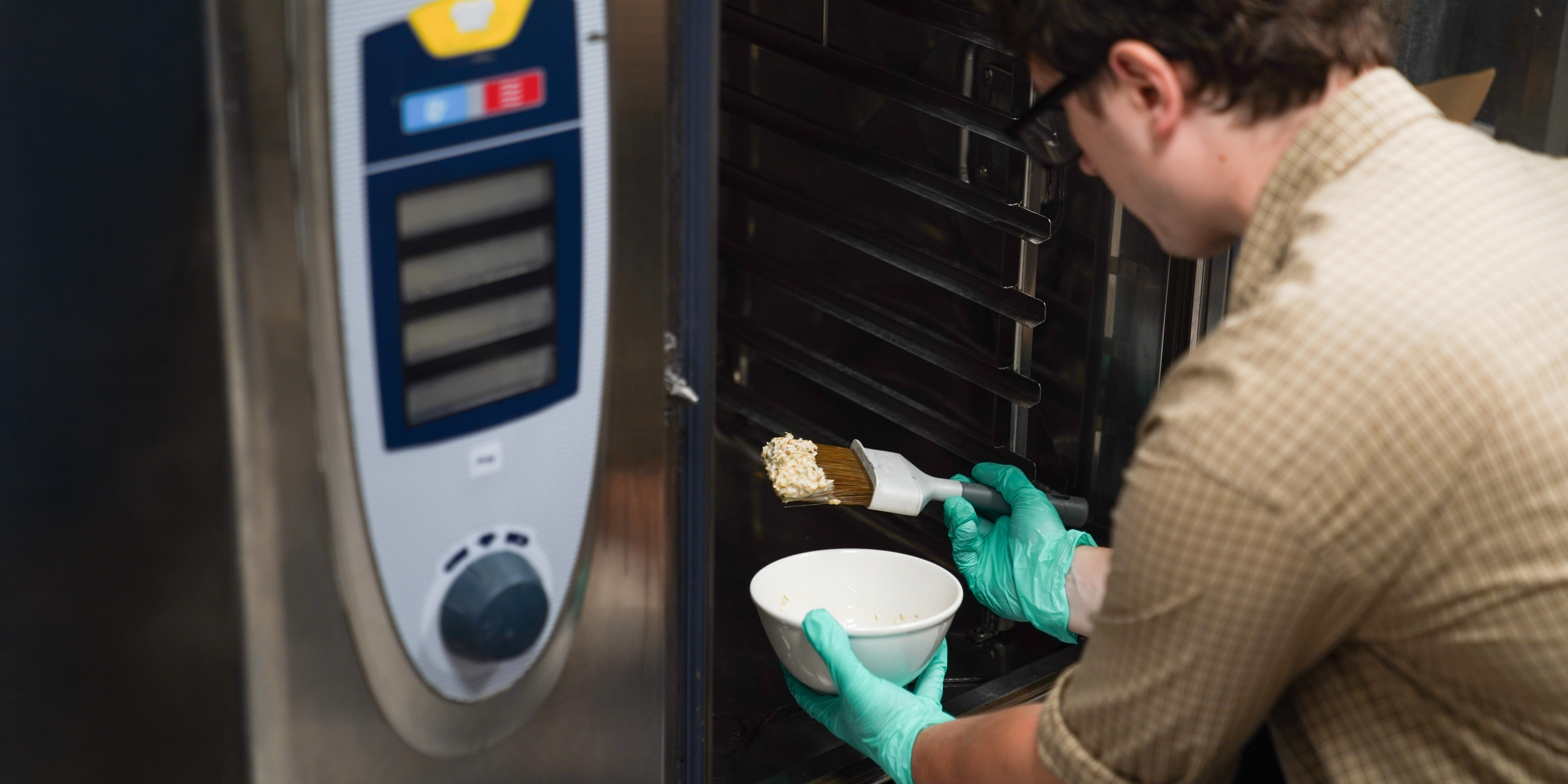 Our tester prepares to smear a concoction on a oven