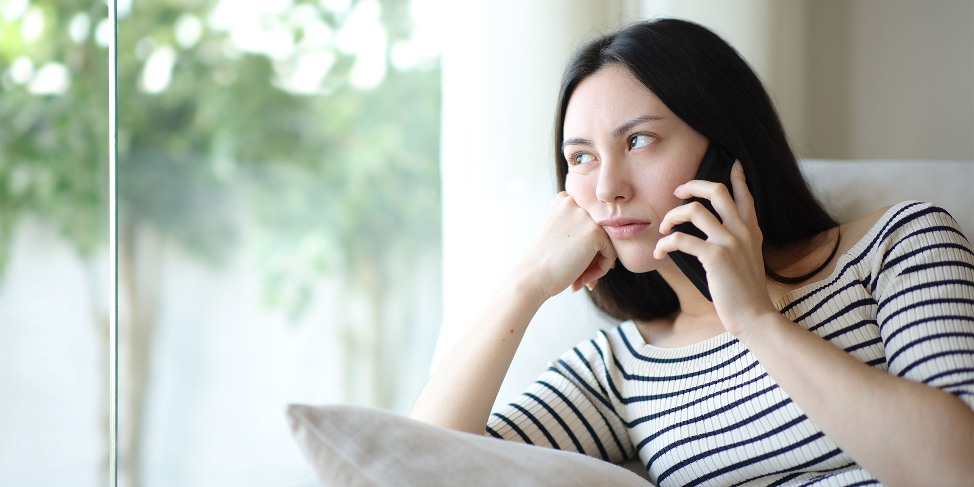 Woman on hold on the phone