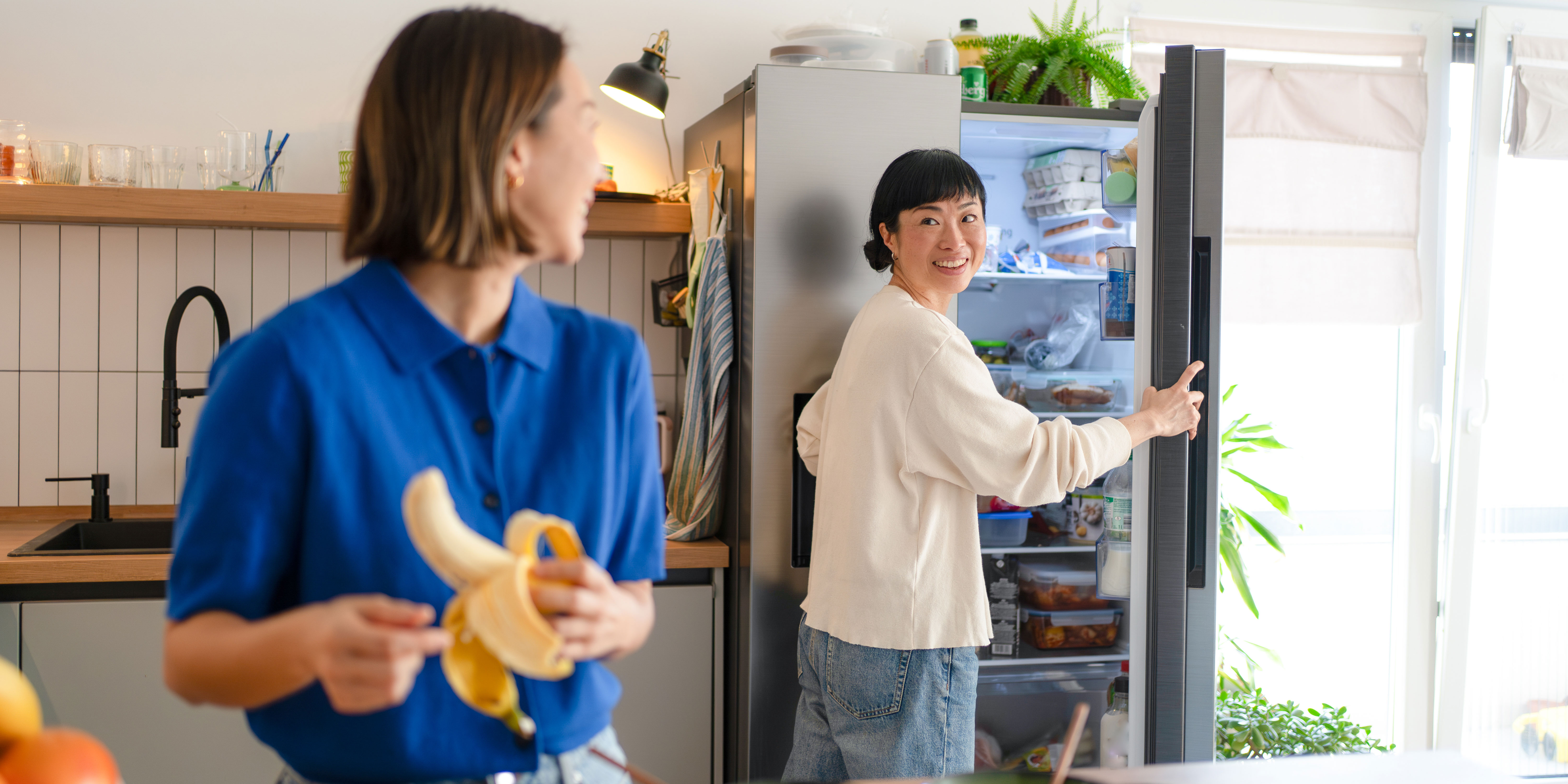 Couple in a kitchen with their American fridge freezer