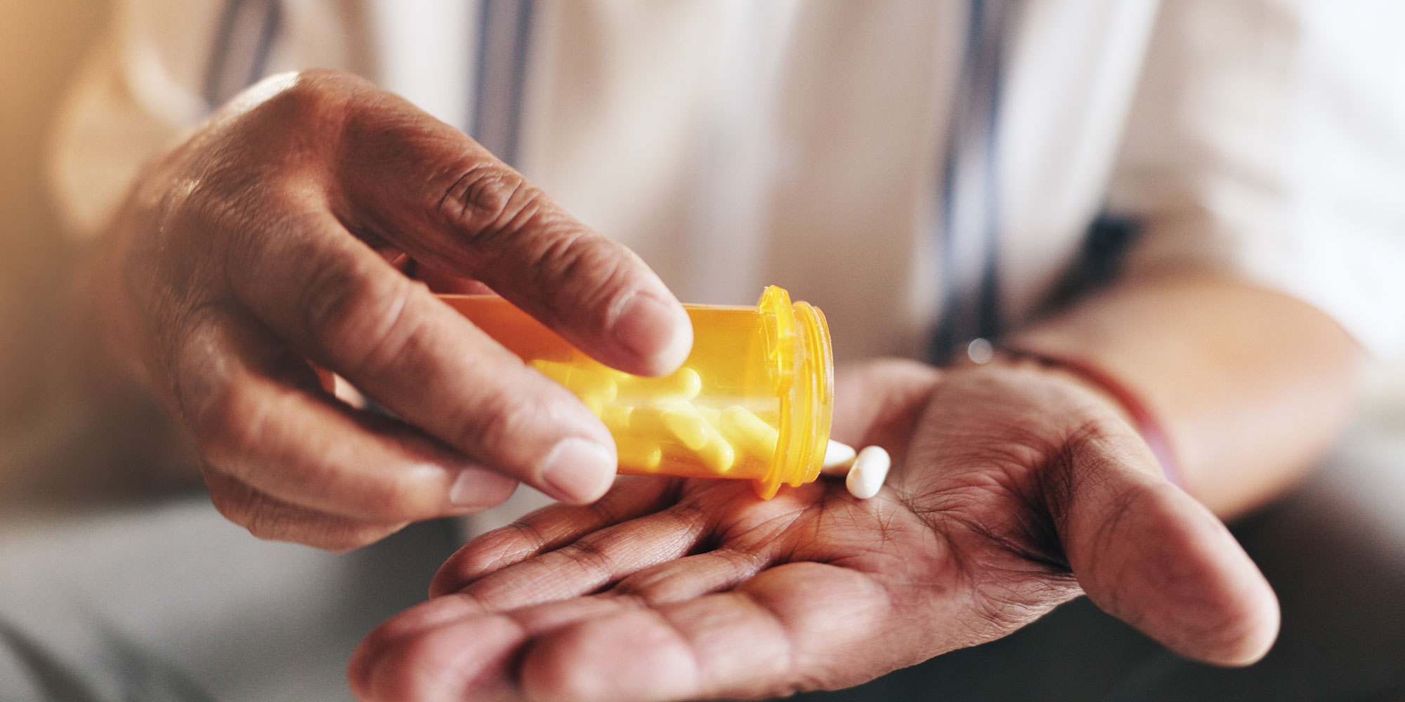 Pouring out pills onto palm