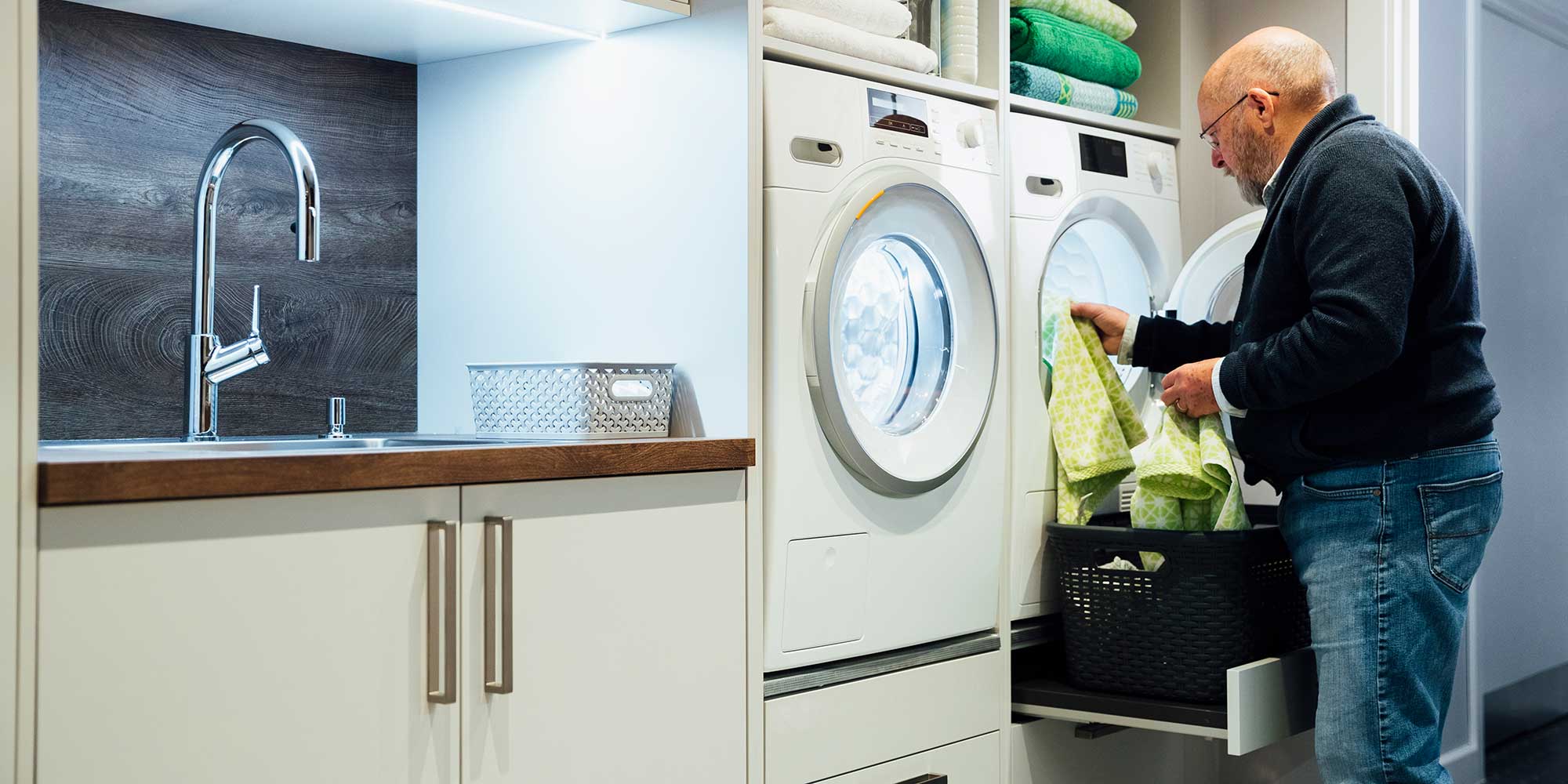 Man loading tumble dryer