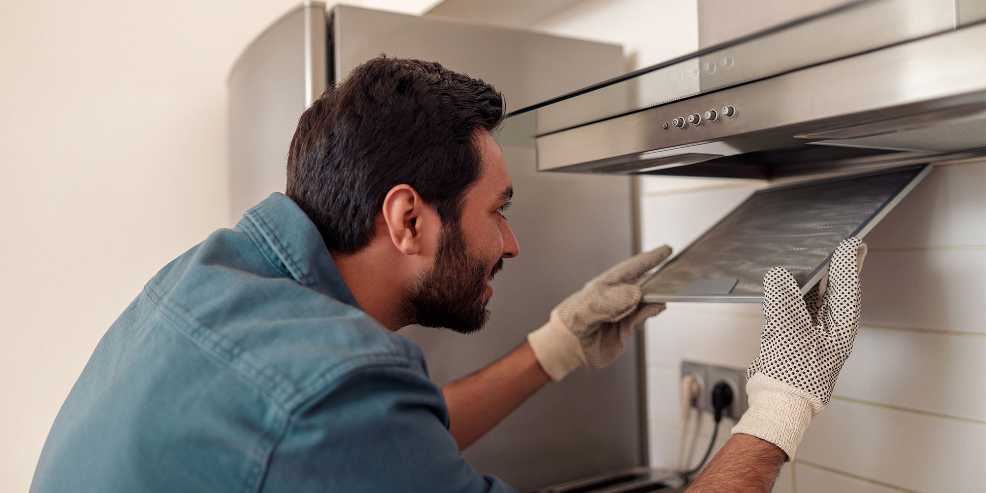Man cleaning a cooker hood