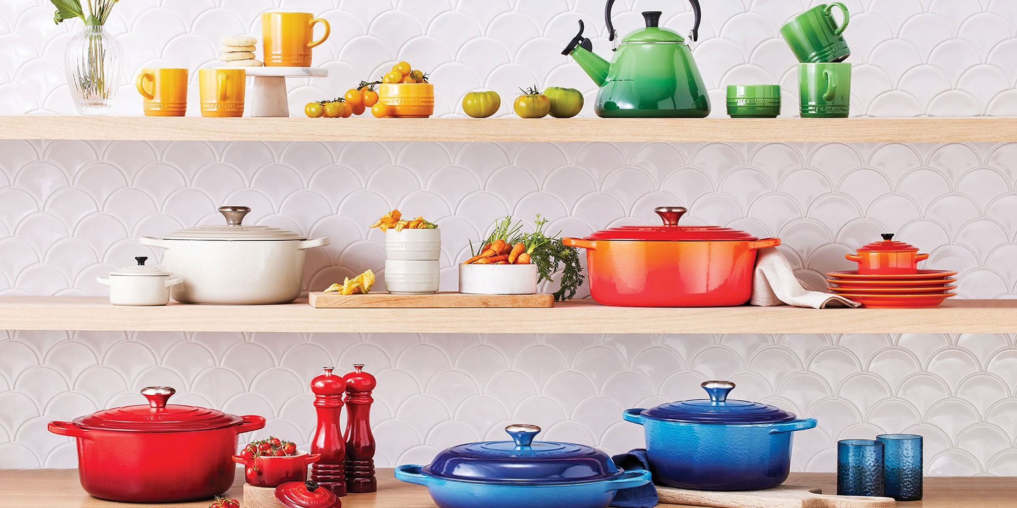 Le Creuset tableware on a shelf