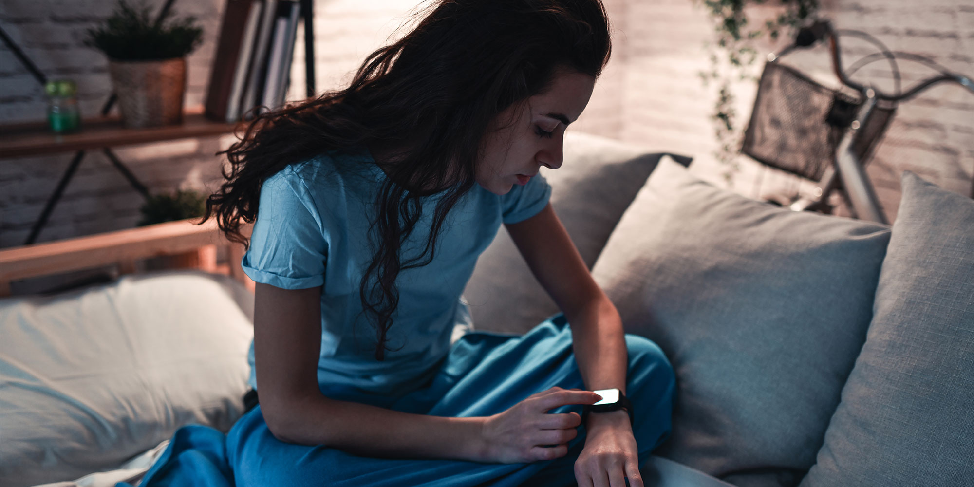 Woman checking smartwatch at night