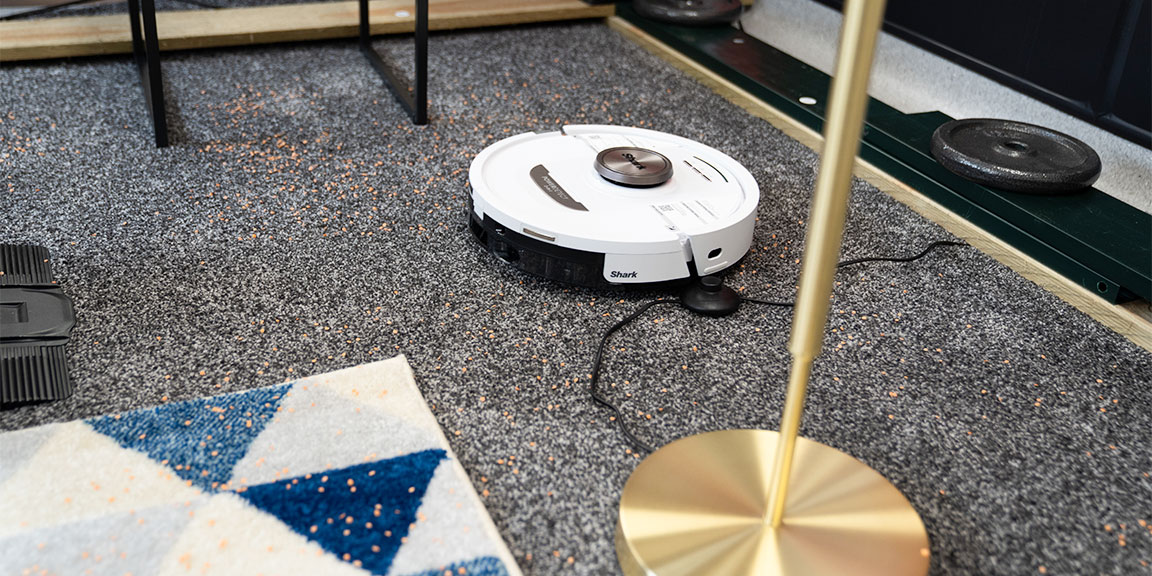 Robot vacuum navigates obstacles including a trailing wire