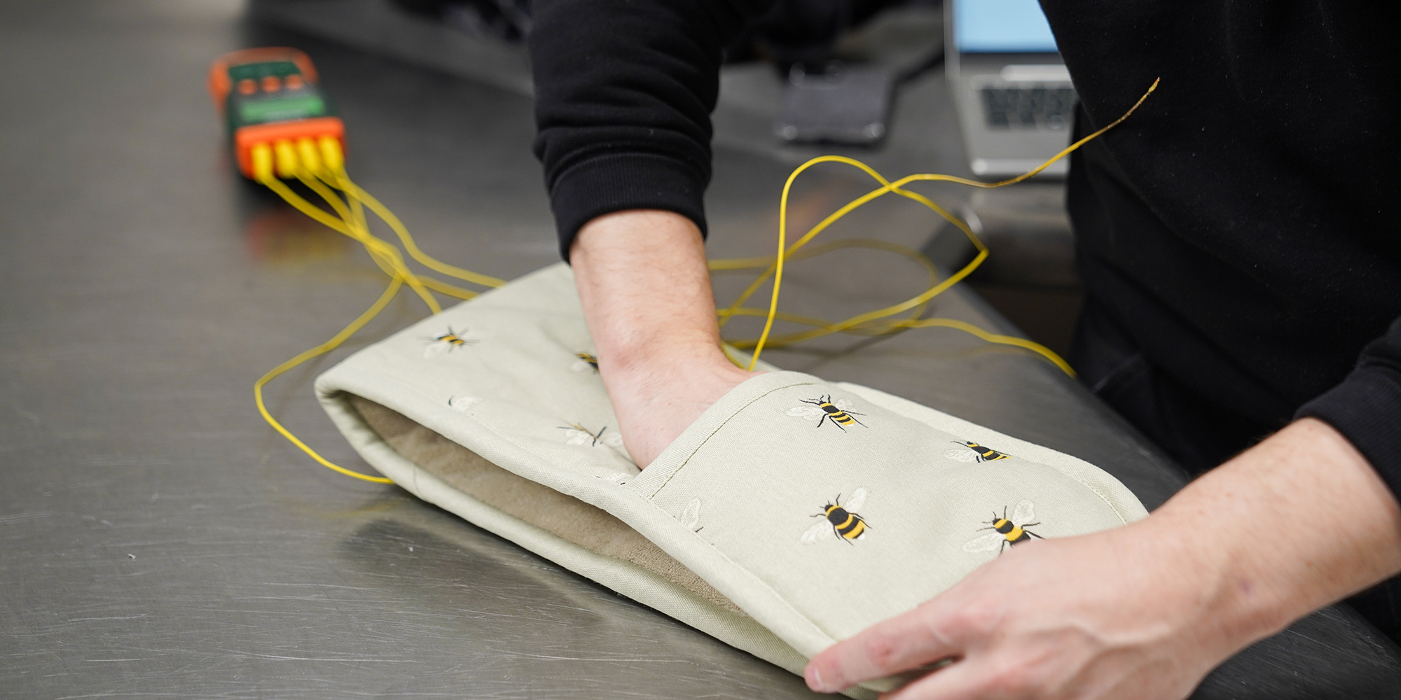 temperature probe being placed inside an oven glove