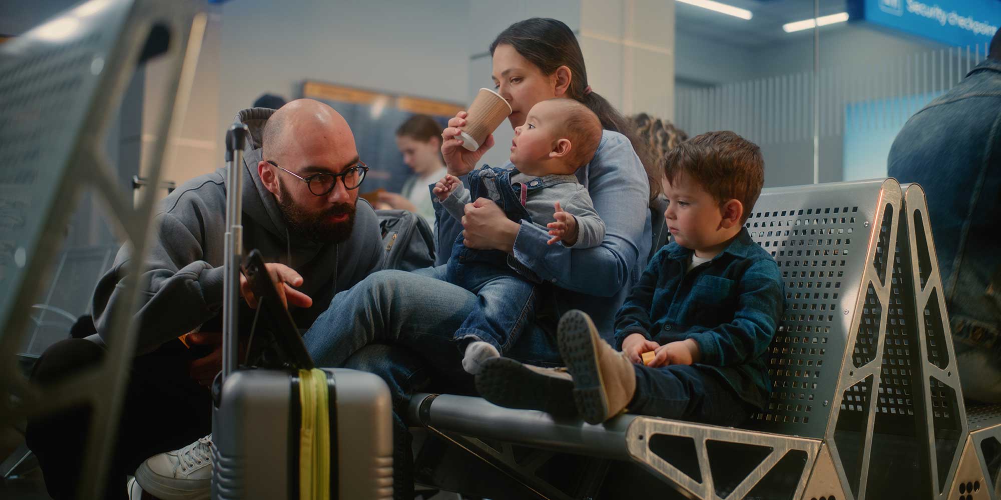 A family sitting in an airport.
