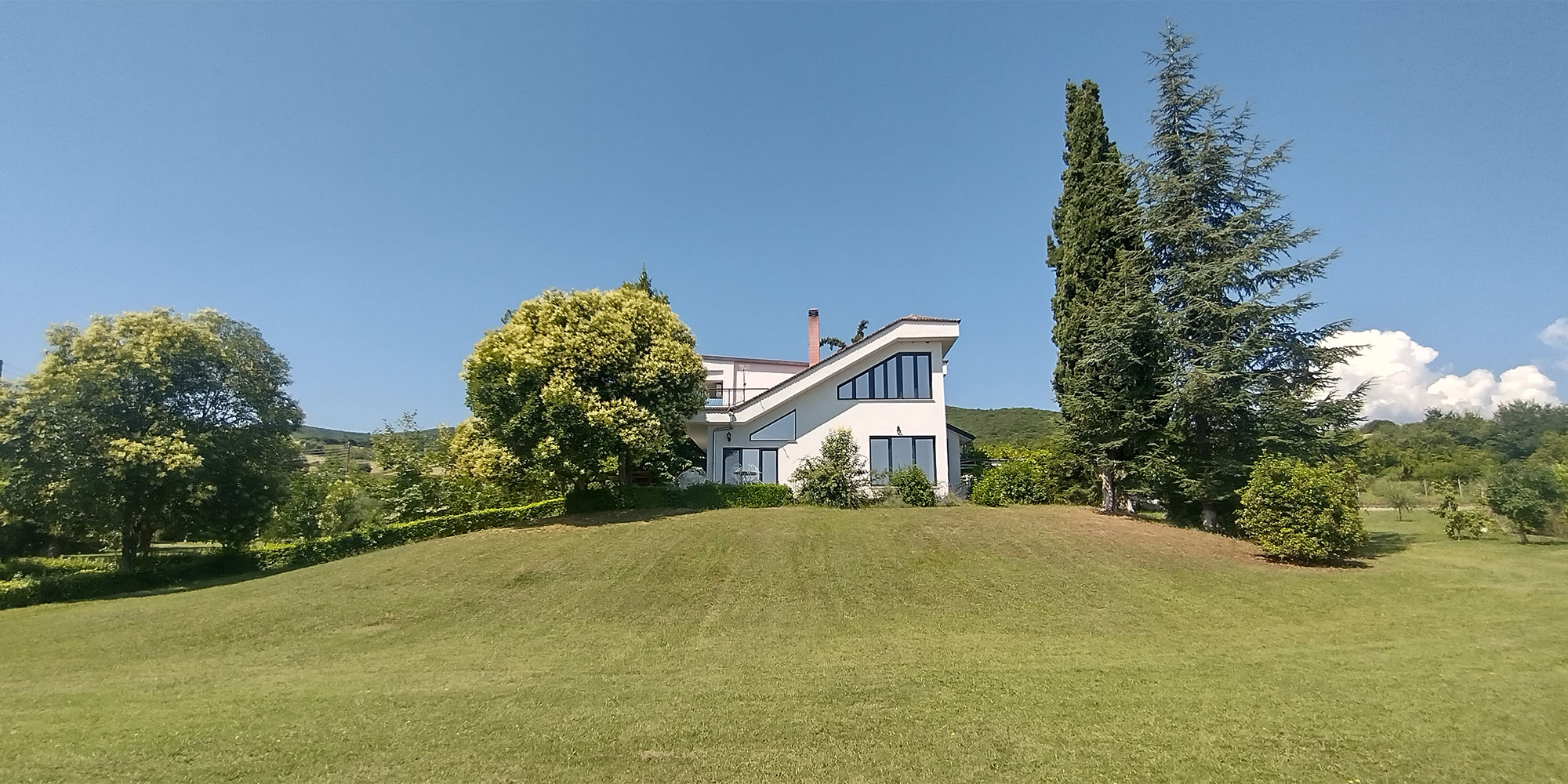 House in a green field in Greece