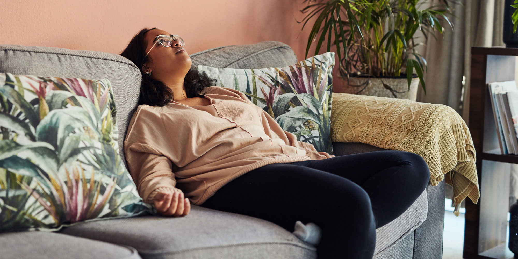 A woman collapsed on sofa, perhaps feeling a sense of January burn-out