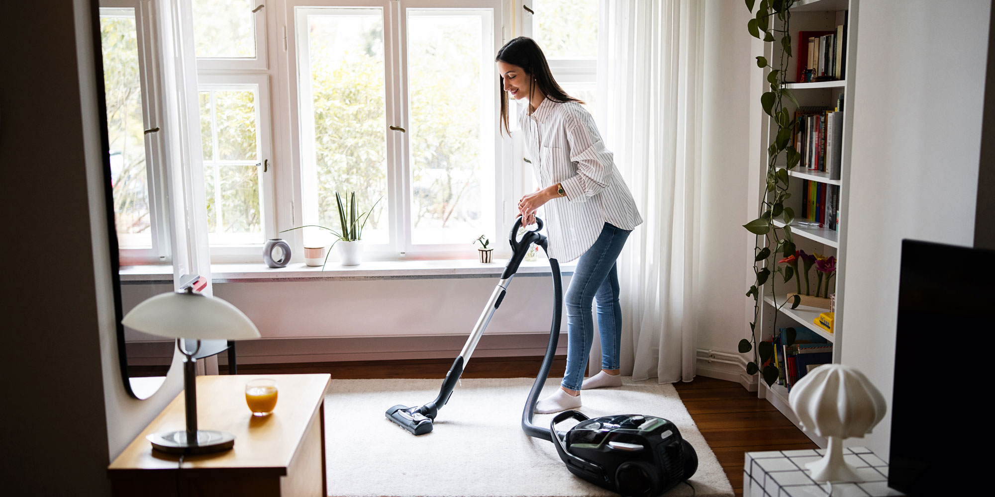 person vacuuming their rug
