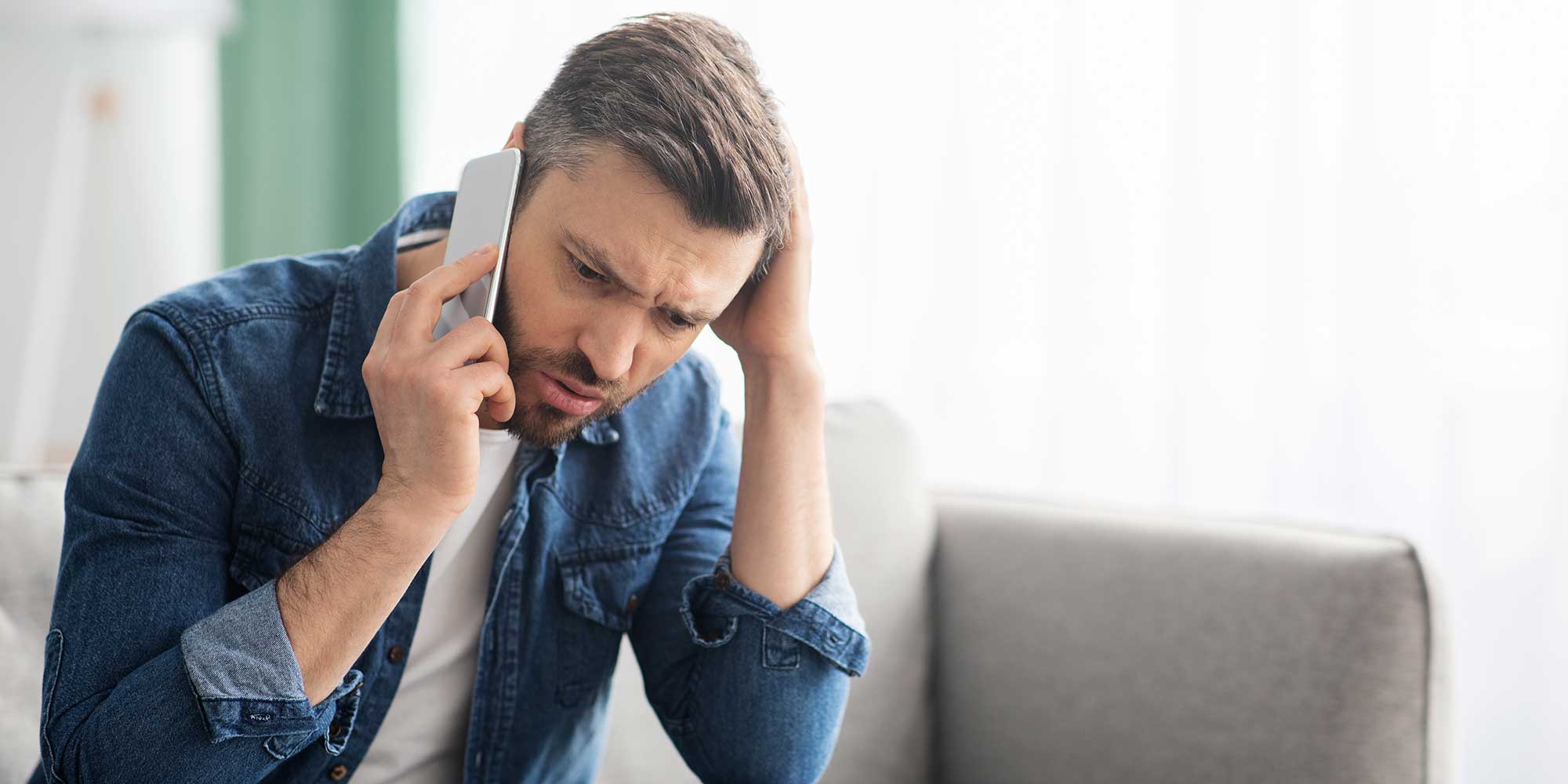 A man on the phone speaking to his energy company