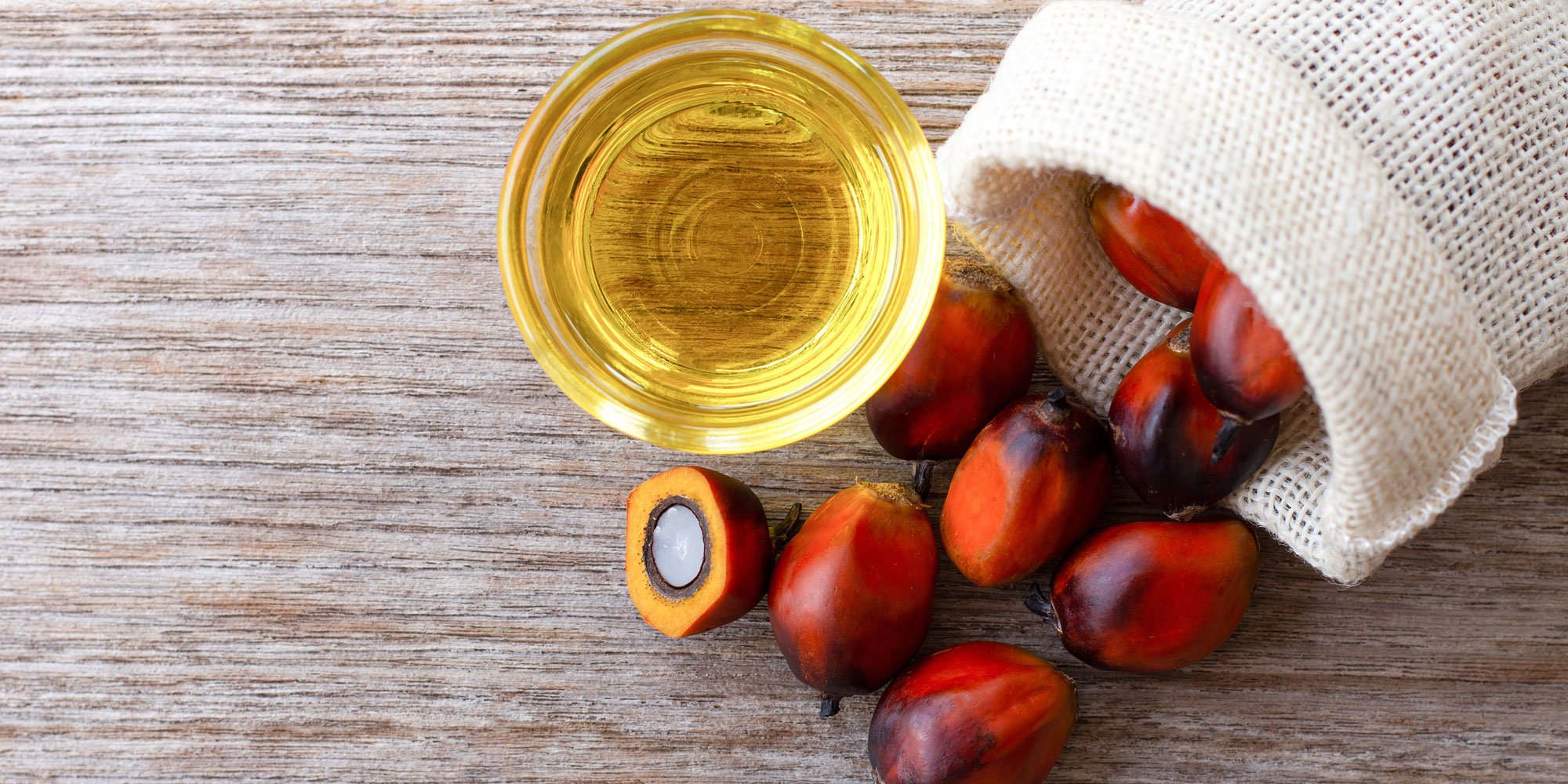 Palm oil fruit with glass of oil