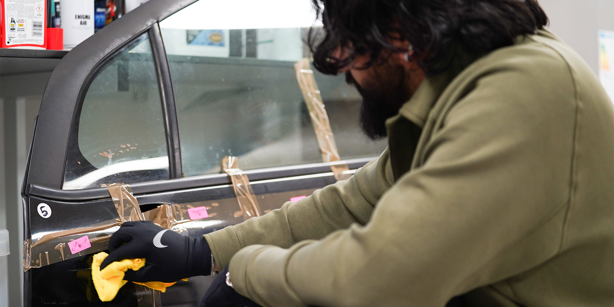 Our expert tester applies car scratch remover with a microfibre cloth