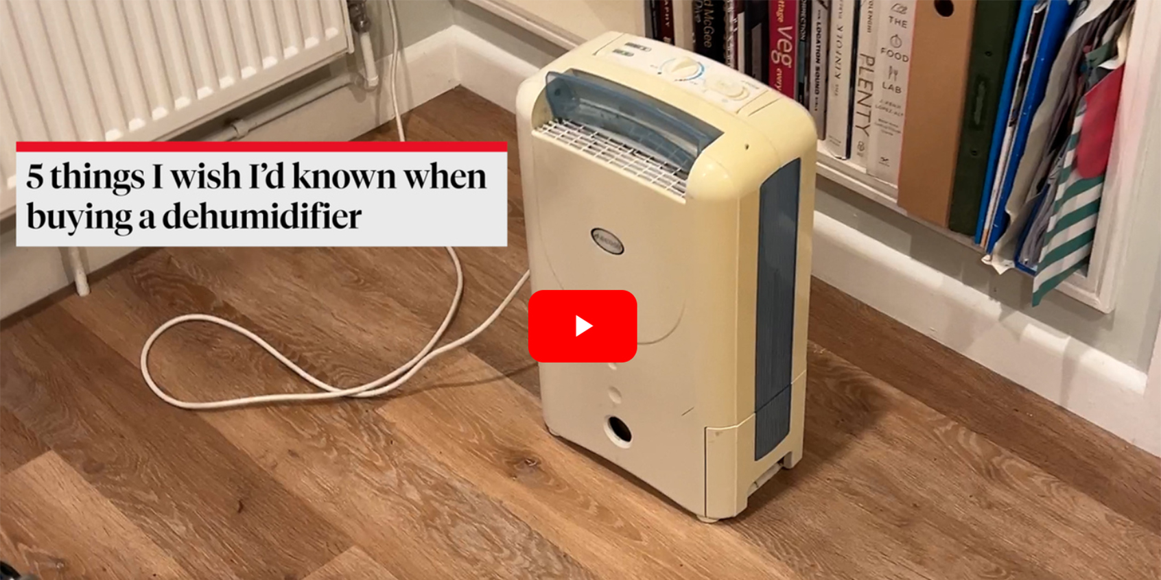A dehumidifier in a room removing damp with a caption to the left