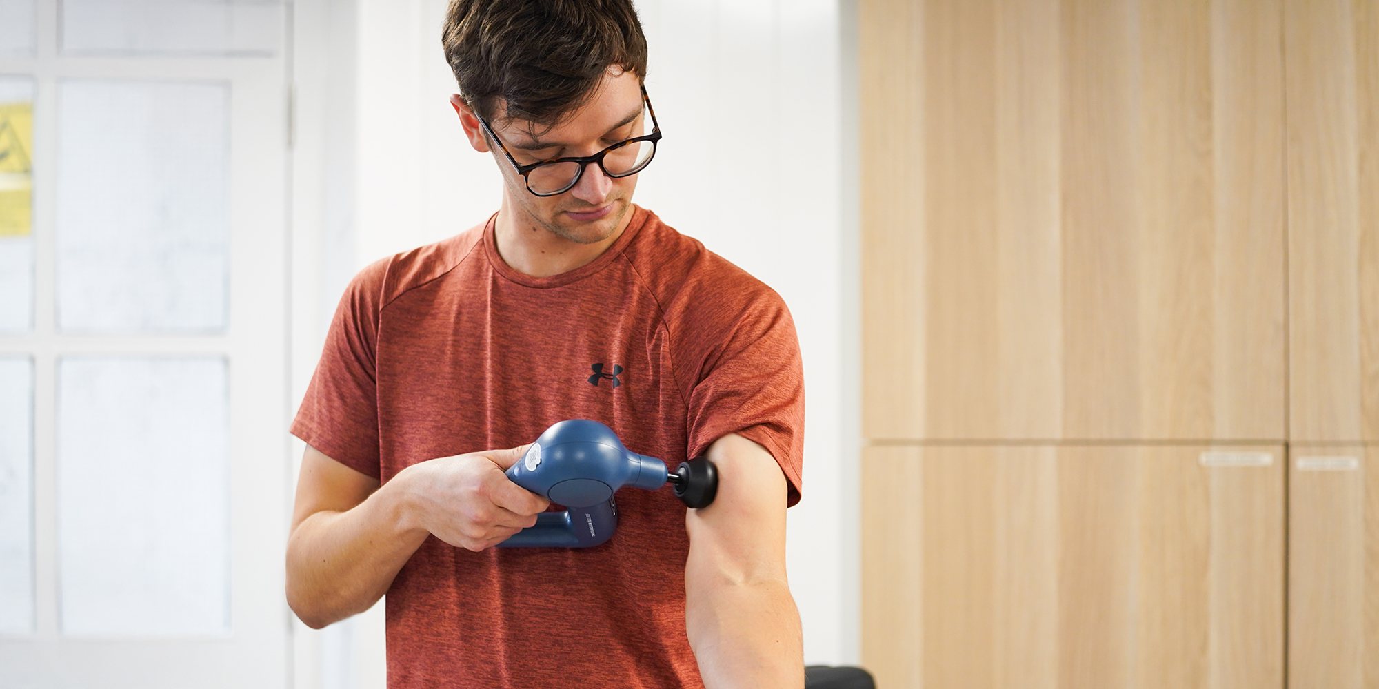 Massage gun being used by Which? tester