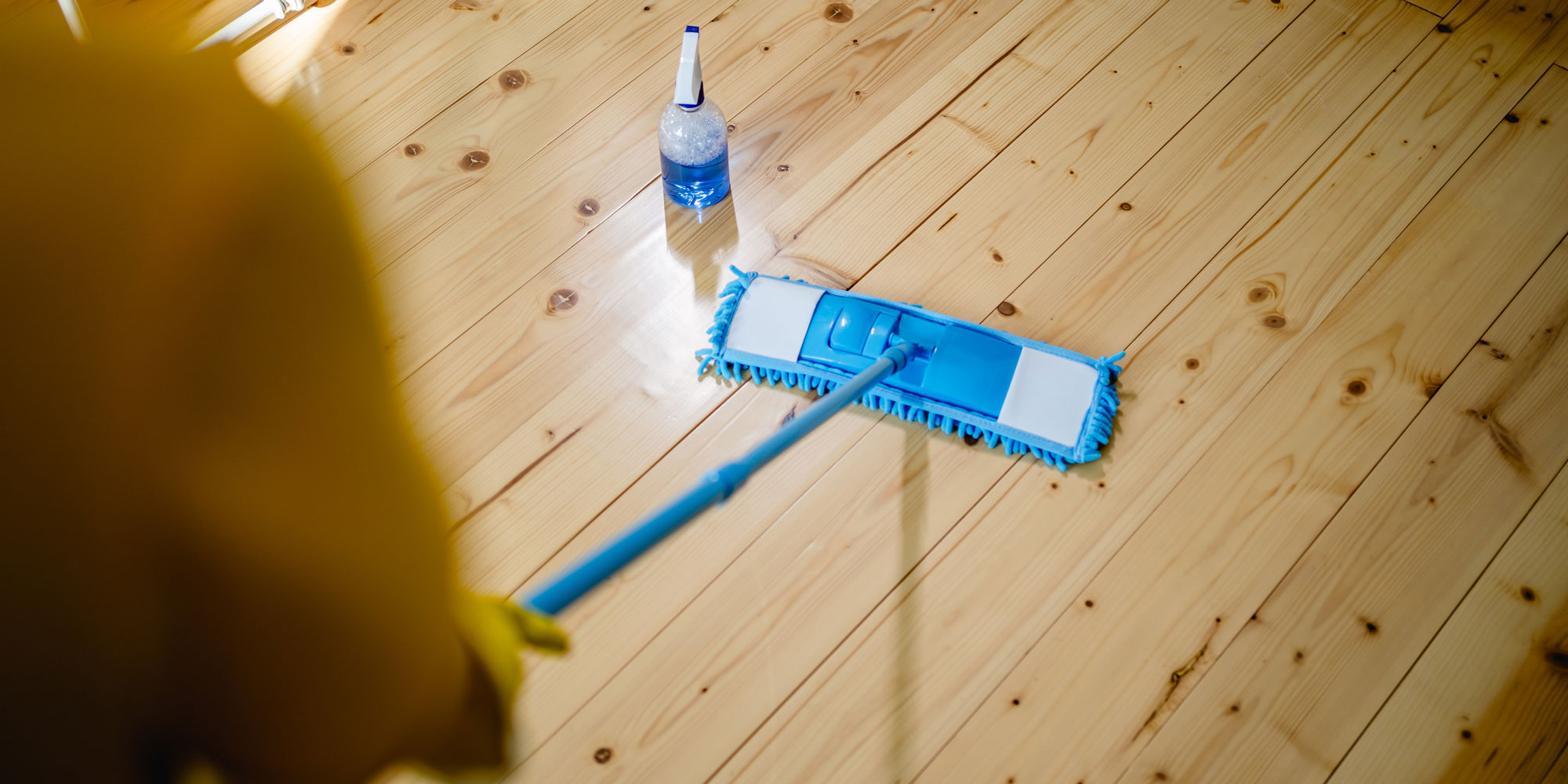 Mopping wooden floor with the grain